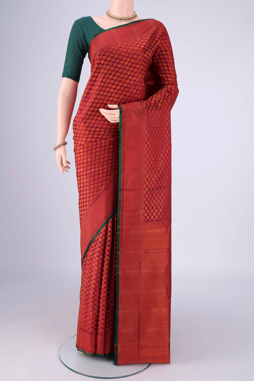 Maroon Kanchipuram Silk Saree with Jacquard design on the body and Thread Border.  displayed on a mannequin