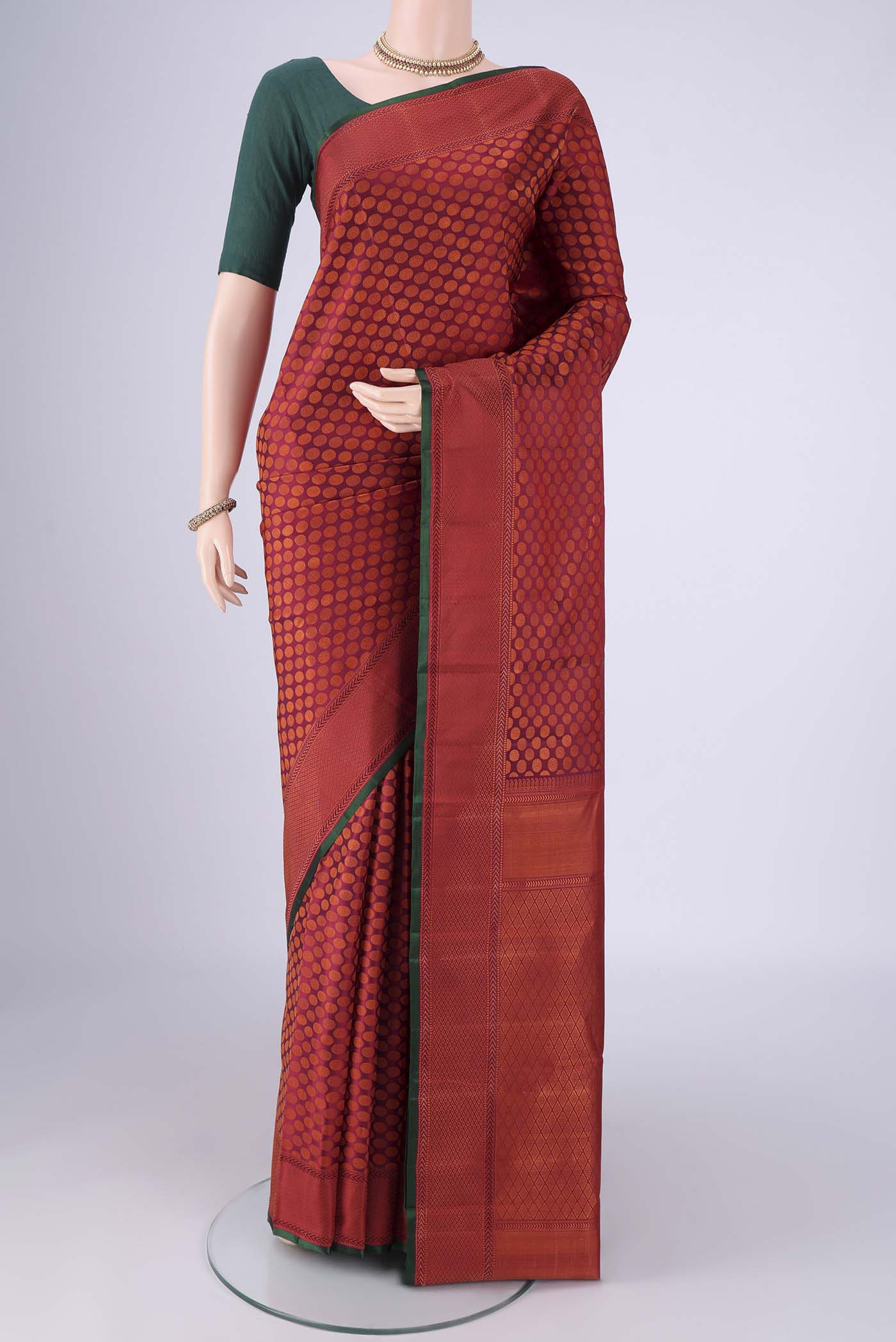 Maroon Kanchipuram Silk Saree with Jacquard design on the body and Thread Border.  displayed on a mannequin