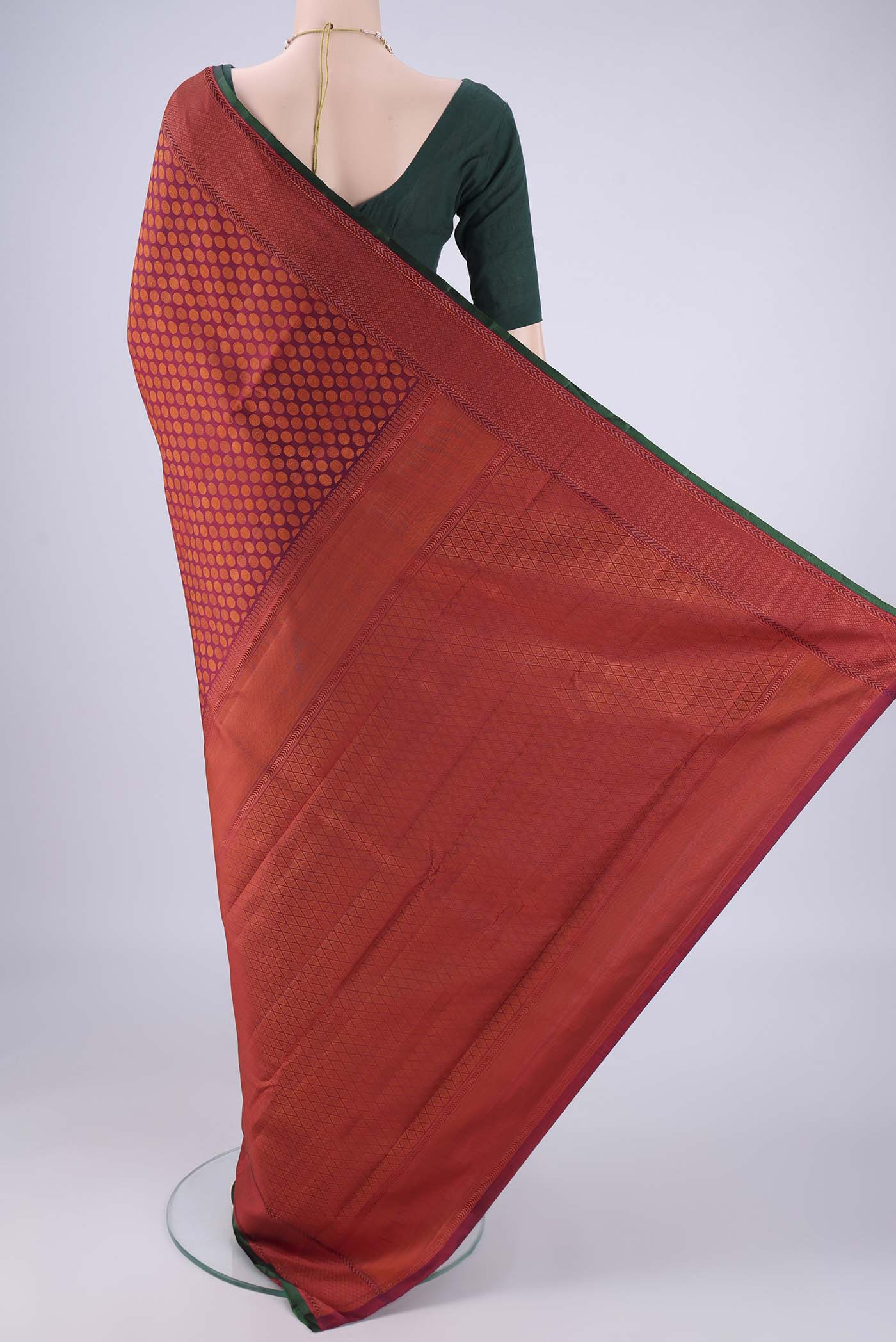 Flat view of Maroon Kanchipuram Silk Saree with Jacquard design on the body and Thread Border. 