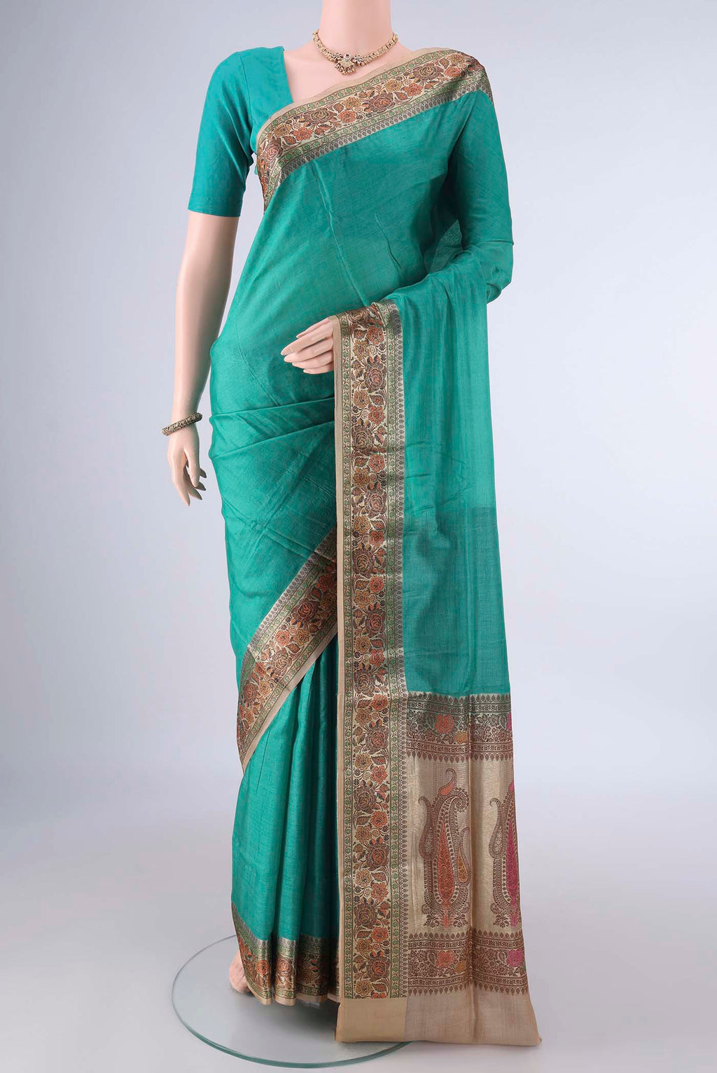 Sea Green Banarasi Tussar Saree with Plain Body and Zari Border.  displayed on a mannequin
