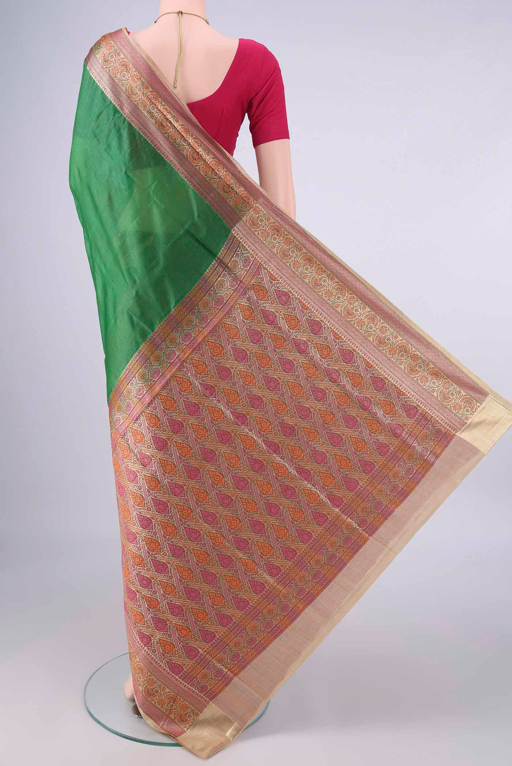 Flat view of Green Banarasi Tussar Saree with Plain Body and Zari Border. 