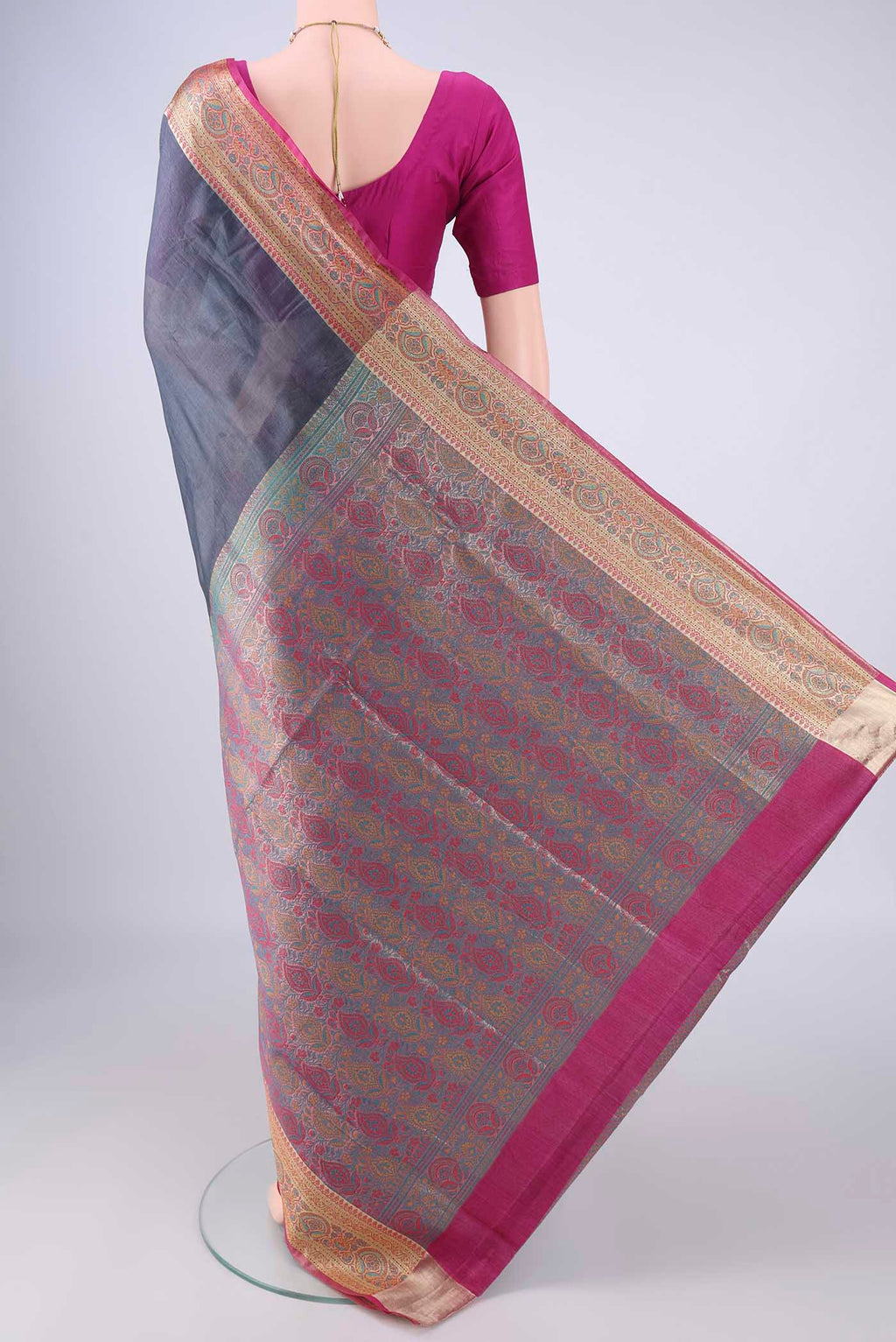 Flat view of Grey Banarasi Tussar Silk Saree with Plain Body and Zari Border. 