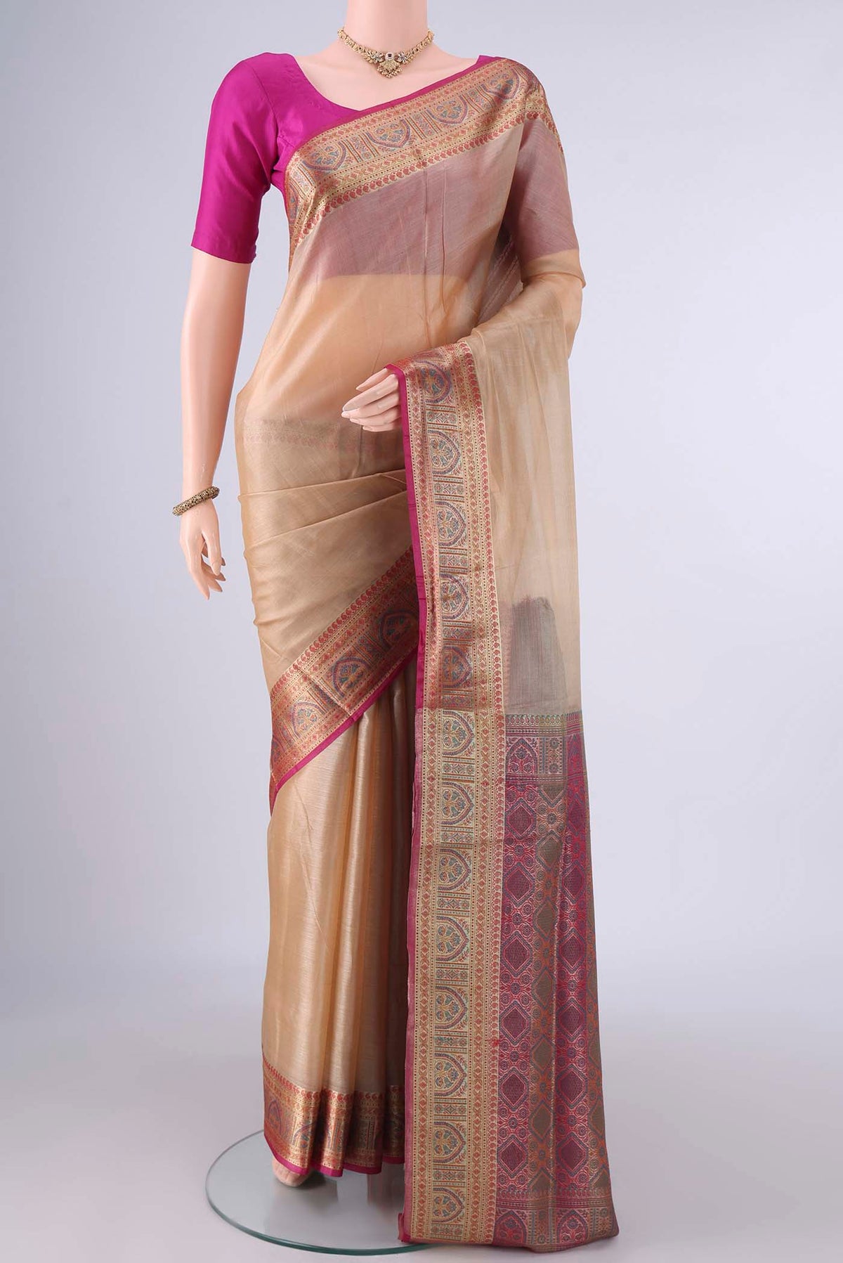 Beige Banarasi Tussar Saree with Plain Body and Zari Border.  displayed on a mannequin