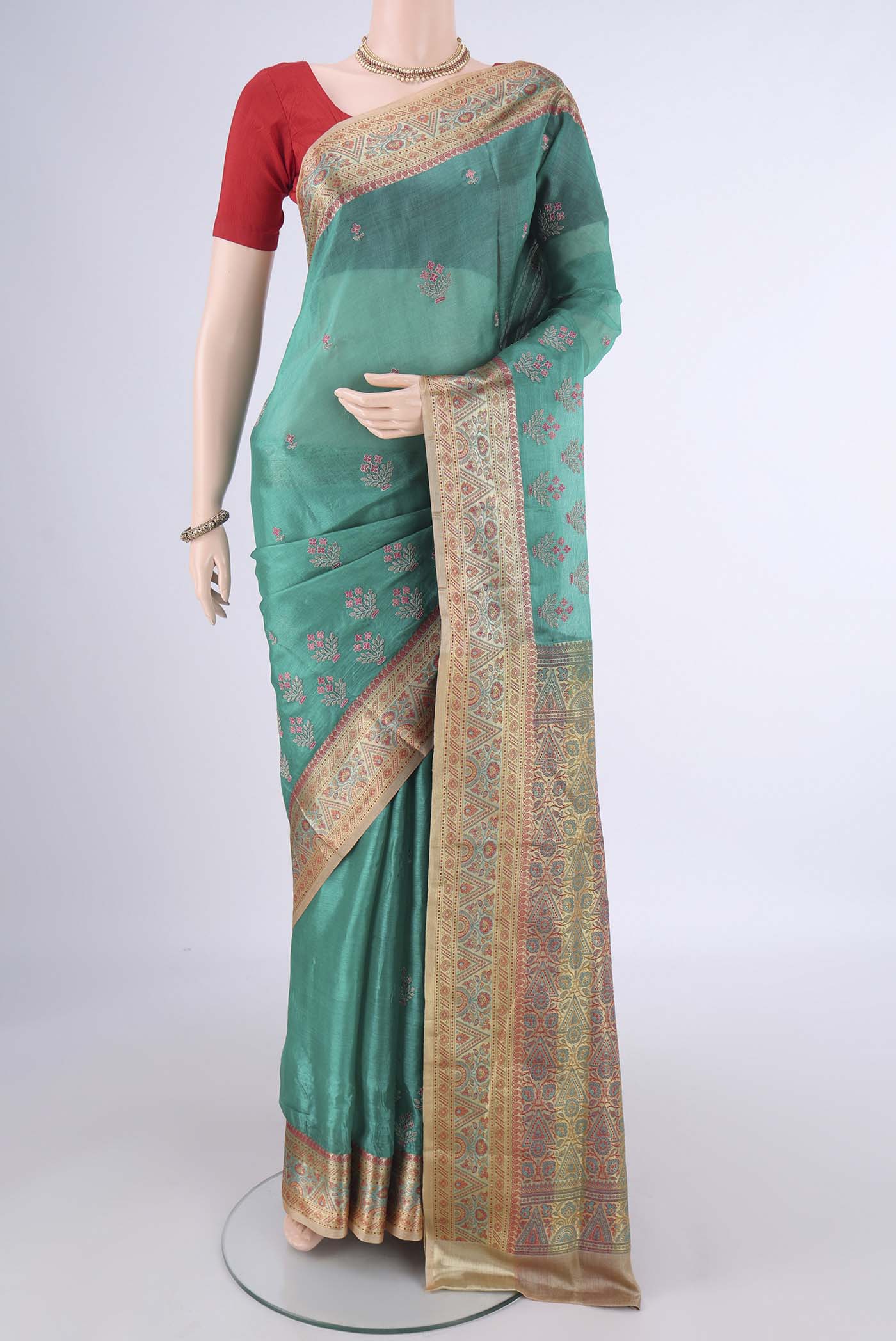 Sea Green Banarasi Tussar Silk Saree with Embroidery on the body and Zari Border.  displayed on a mannequin