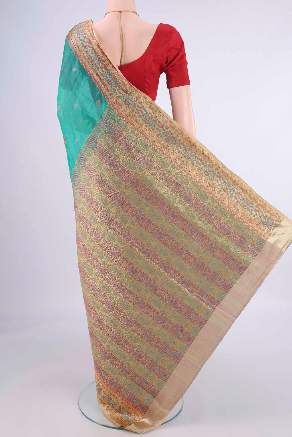 Flat view of Sea Green Banarasi Tussar Silk Saree with Embroidery on the body and Zari Border. 