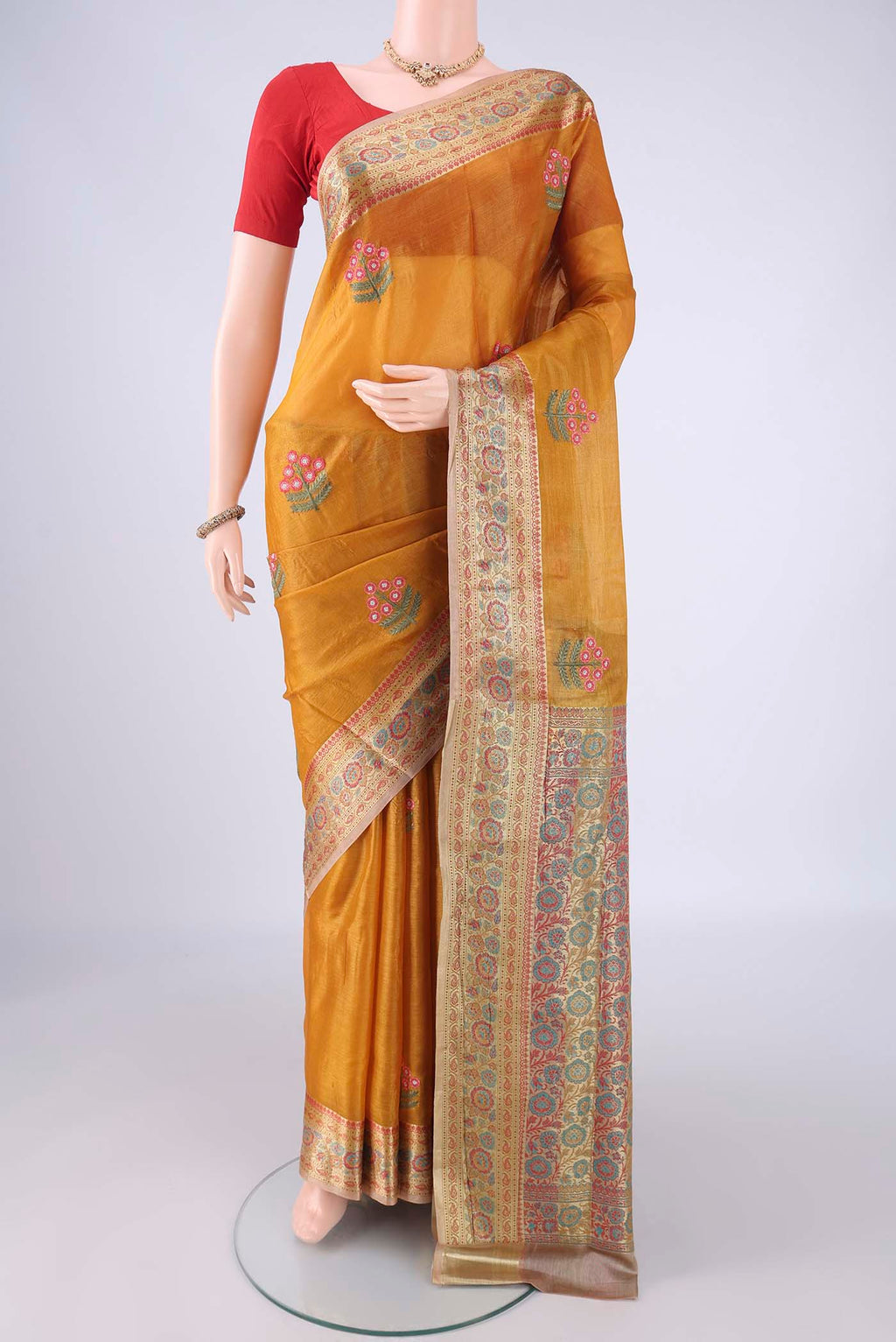 Mustard Banarasi Tussar Silk Saree with Embroidery on the body and Zari Border.  displayed on a mannequin