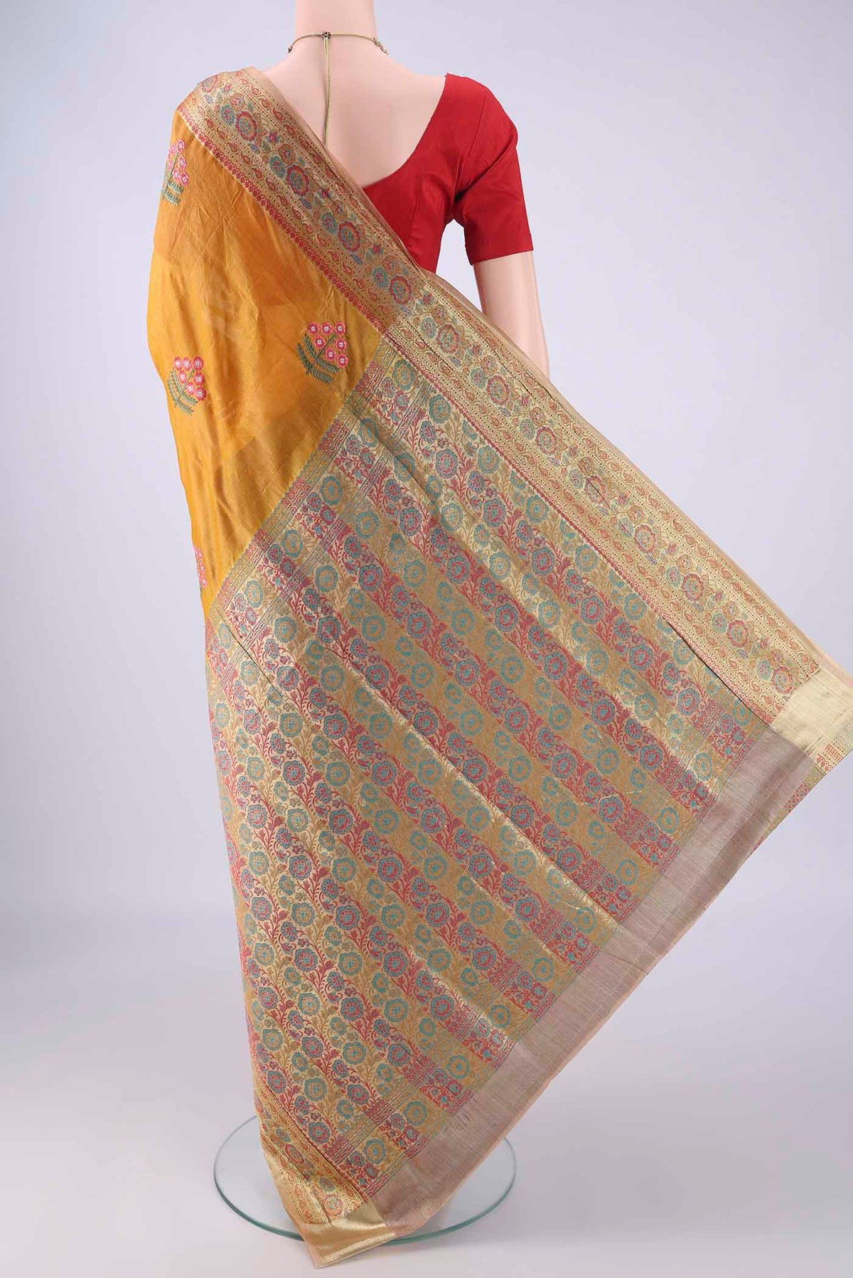 Flat view of Mustard Banarasi Tussar Silk Saree with Embroidery on the body and Zari Border. 