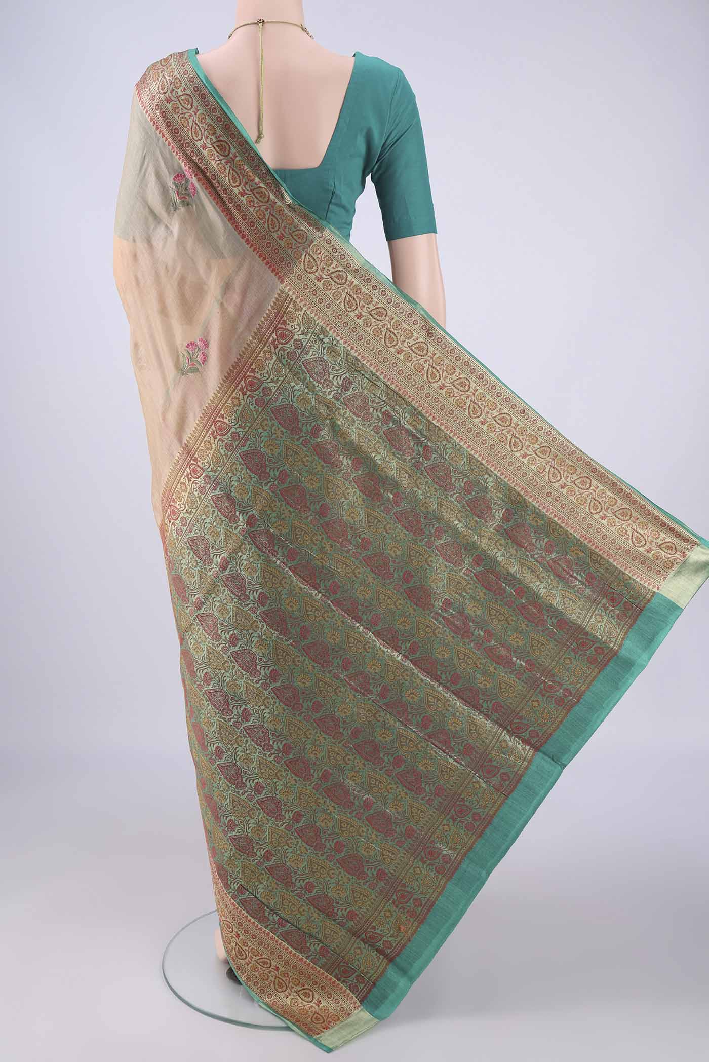Flat view of Beige Banarasi Tussar Silk Saree with Embroidery on the body and Zari Border. 