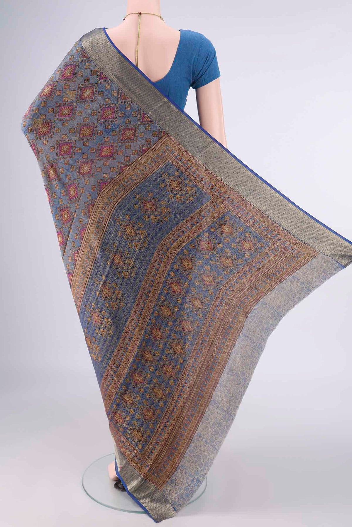 Flat view of Light Blue Mysore Crepe Saree with Printed design on the body and Zari Border. 