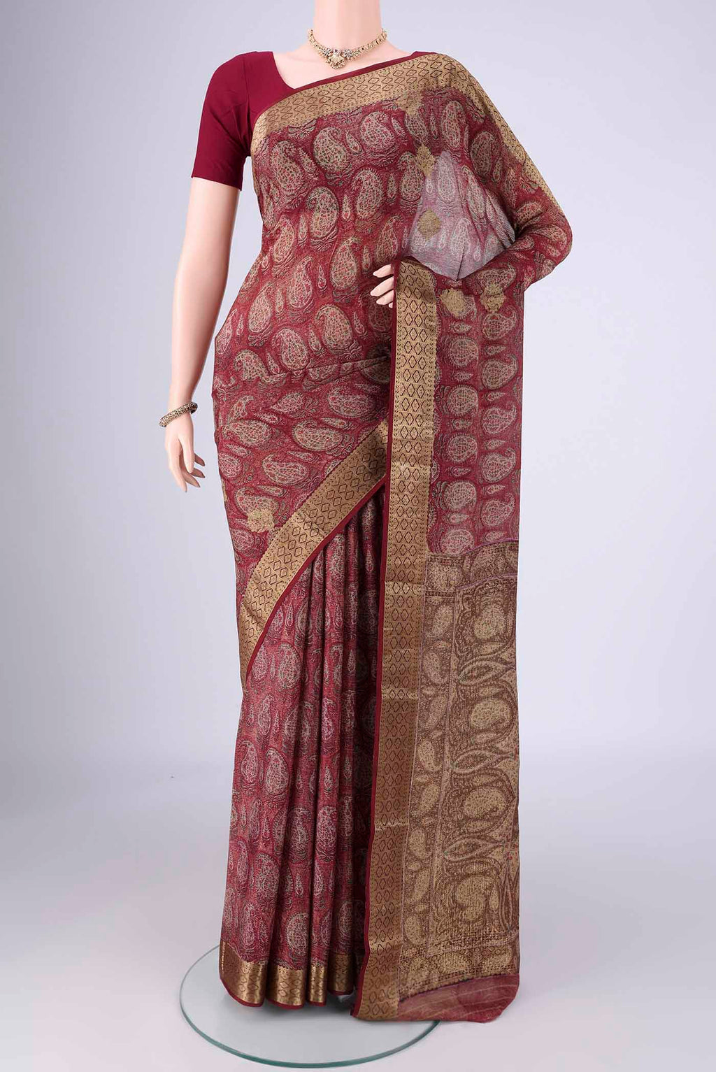 Maroon Mysore Crepe Saree with Printed design on the body and Zari Border.  displayed on a mannequin