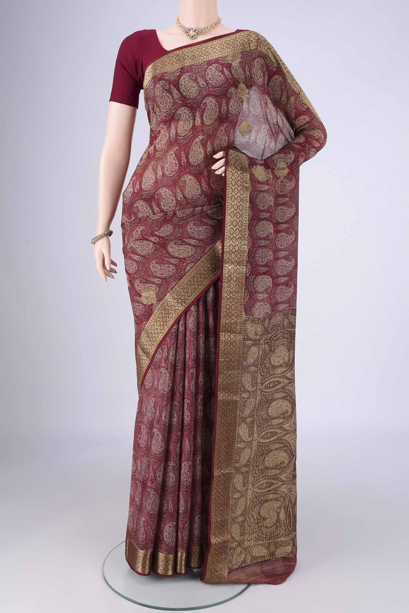 Maroon Mysore Crepe Saree with Printed design on the body and Zari Border.  displayed on a mannequin