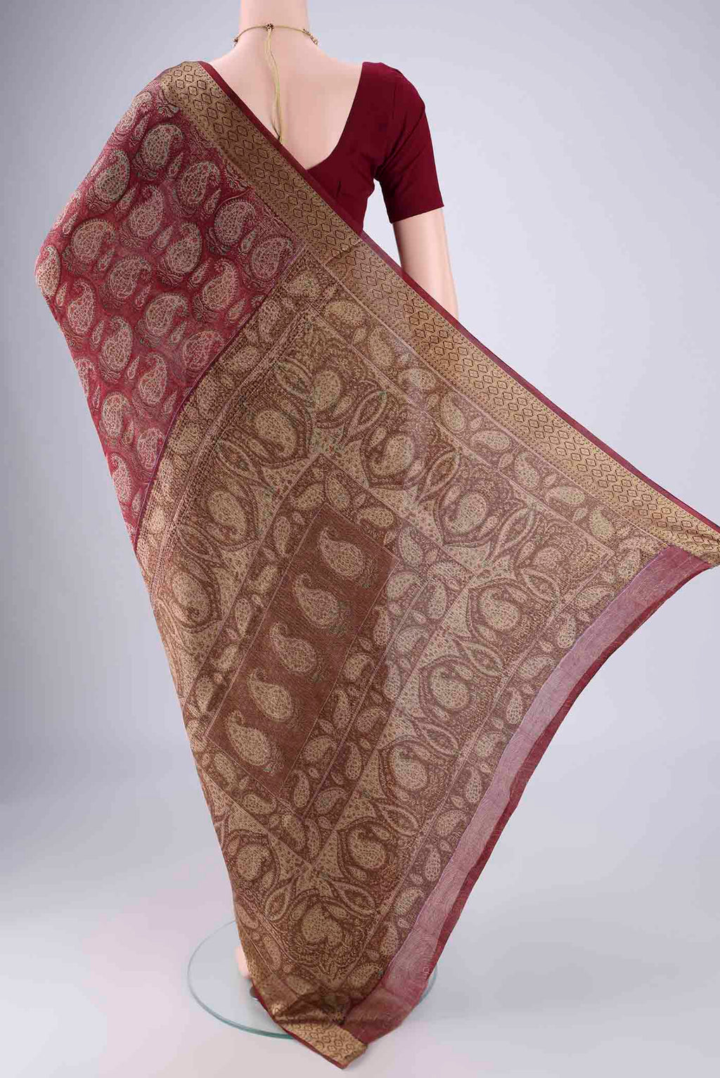 Flat view of Maroon Mysore Crepe Saree with Printed design on the body and Zari Border. 