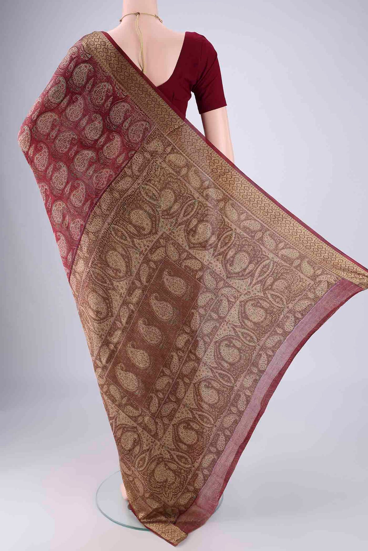 Flat view of Maroon Mysore Crepe Saree with Printed design on the body and Zari Border. 