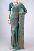 Turquoise Crepe Saree with Floral Print on the body and Zari Border.  displayed on a mannequin