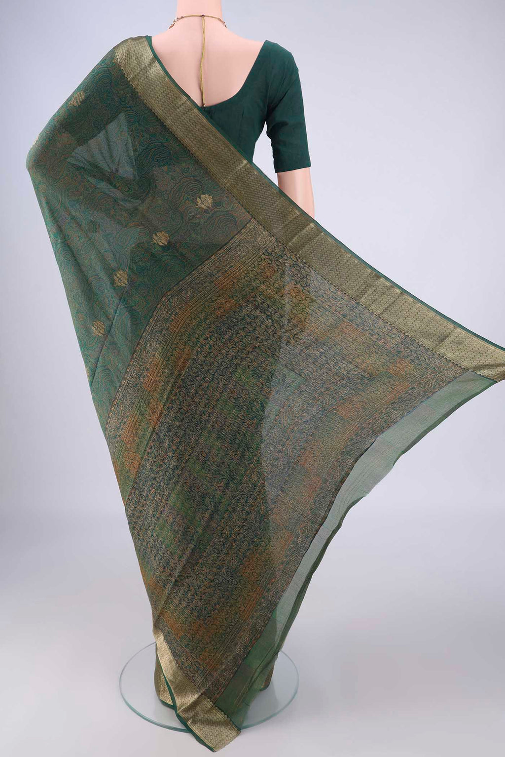 Flat view of Bottle Green Crepe Saree with Floral Print on the body and Zari Border. 