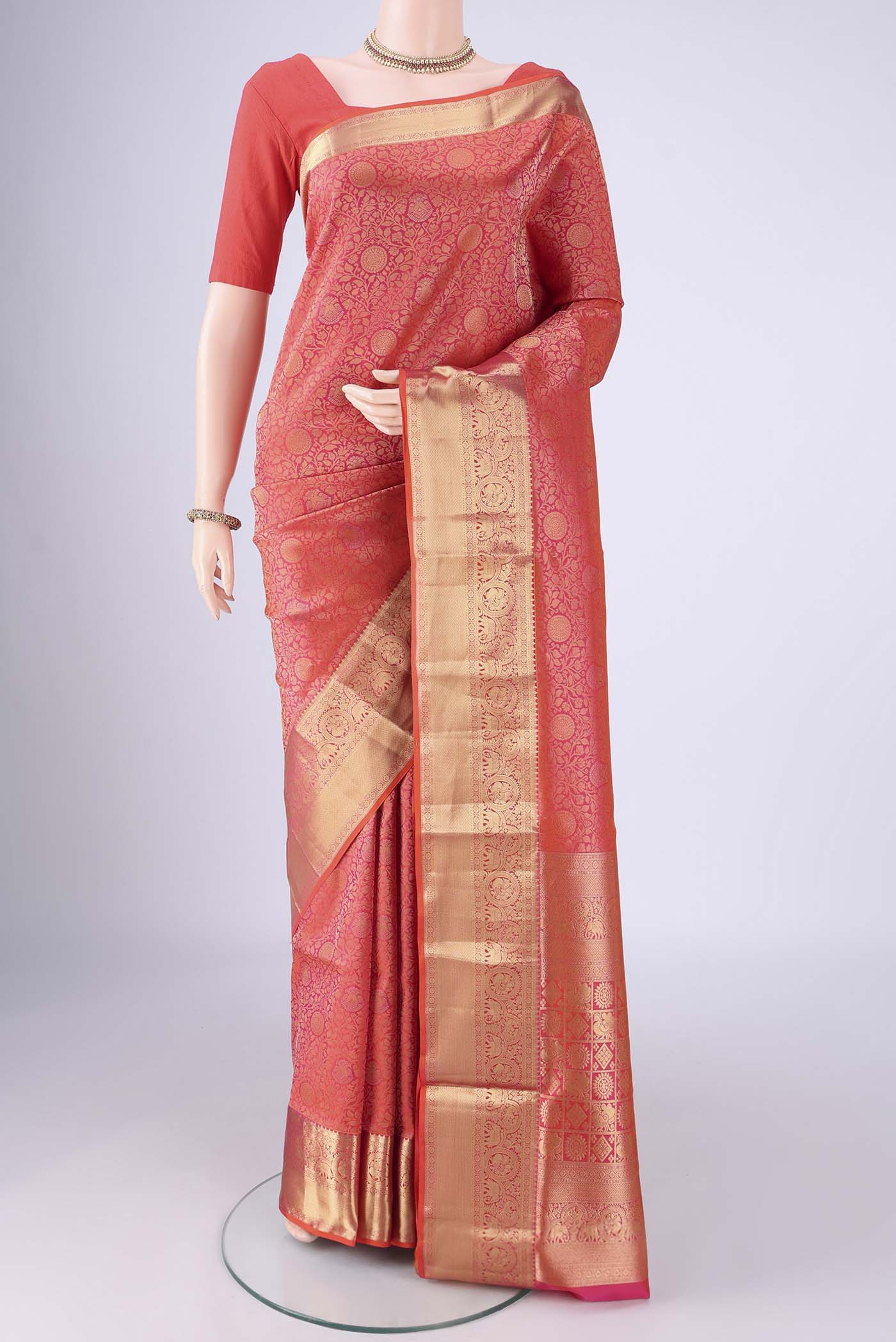 Brick Orange Soft Silk Saree with Zari Brocade on the body and Zari Border.  displayed on a mannequin