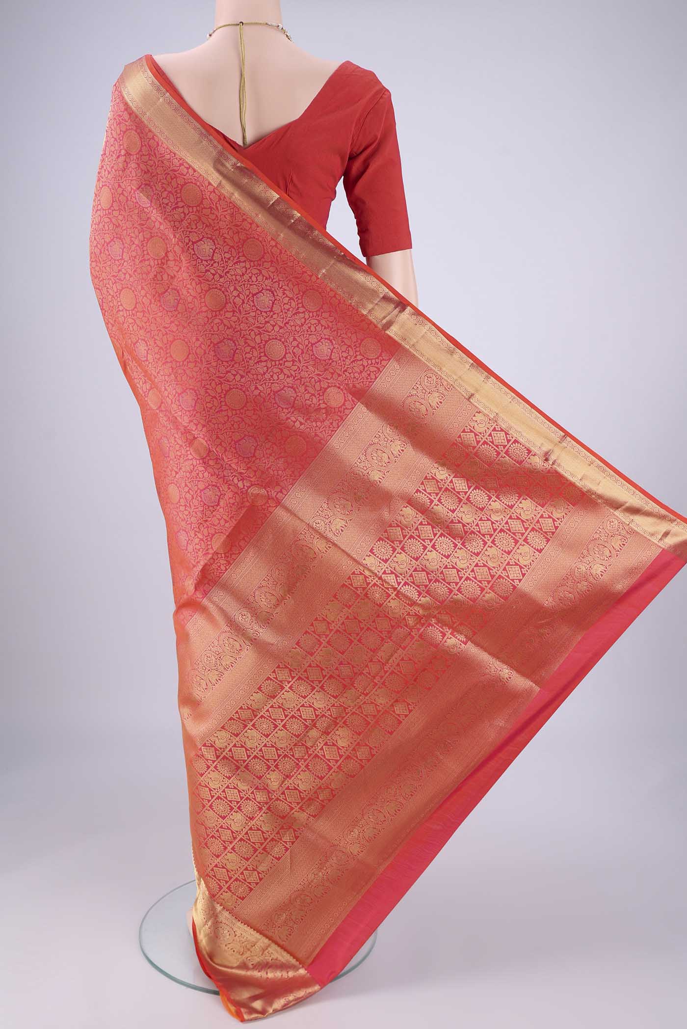 Flat view of Brick Orange Soft Silk Saree with Zari Brocade on the body and Zari Border. 
