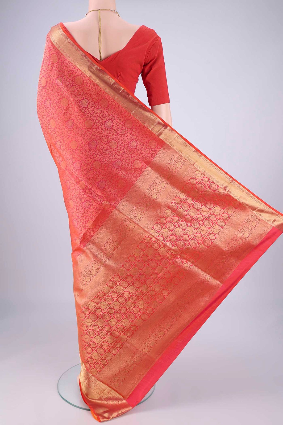 Flat view of Brick Orange Soft Silk Saree with Zari Brocade on the body and Zari Border. 