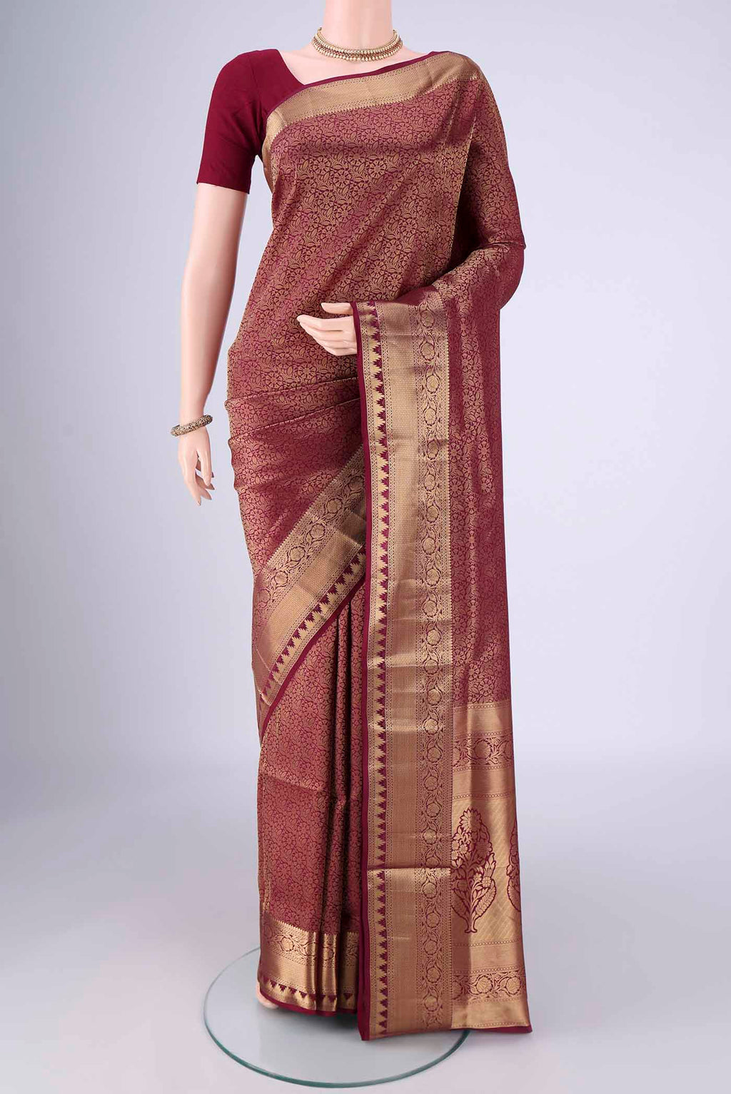 Maroon Soft Silk Saree with Zari Brocade on the body and Zari Border.  displayed on a mannequin