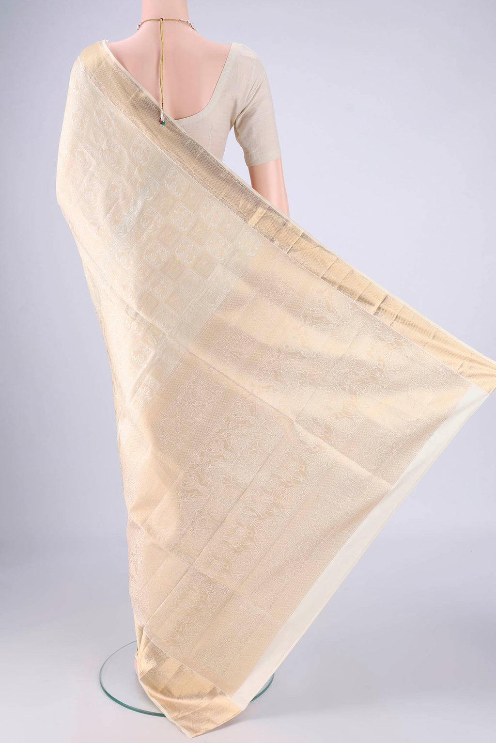 Flat view of Off White Soft Silk Saree with Zari Brocade on the body and Zari Border. 