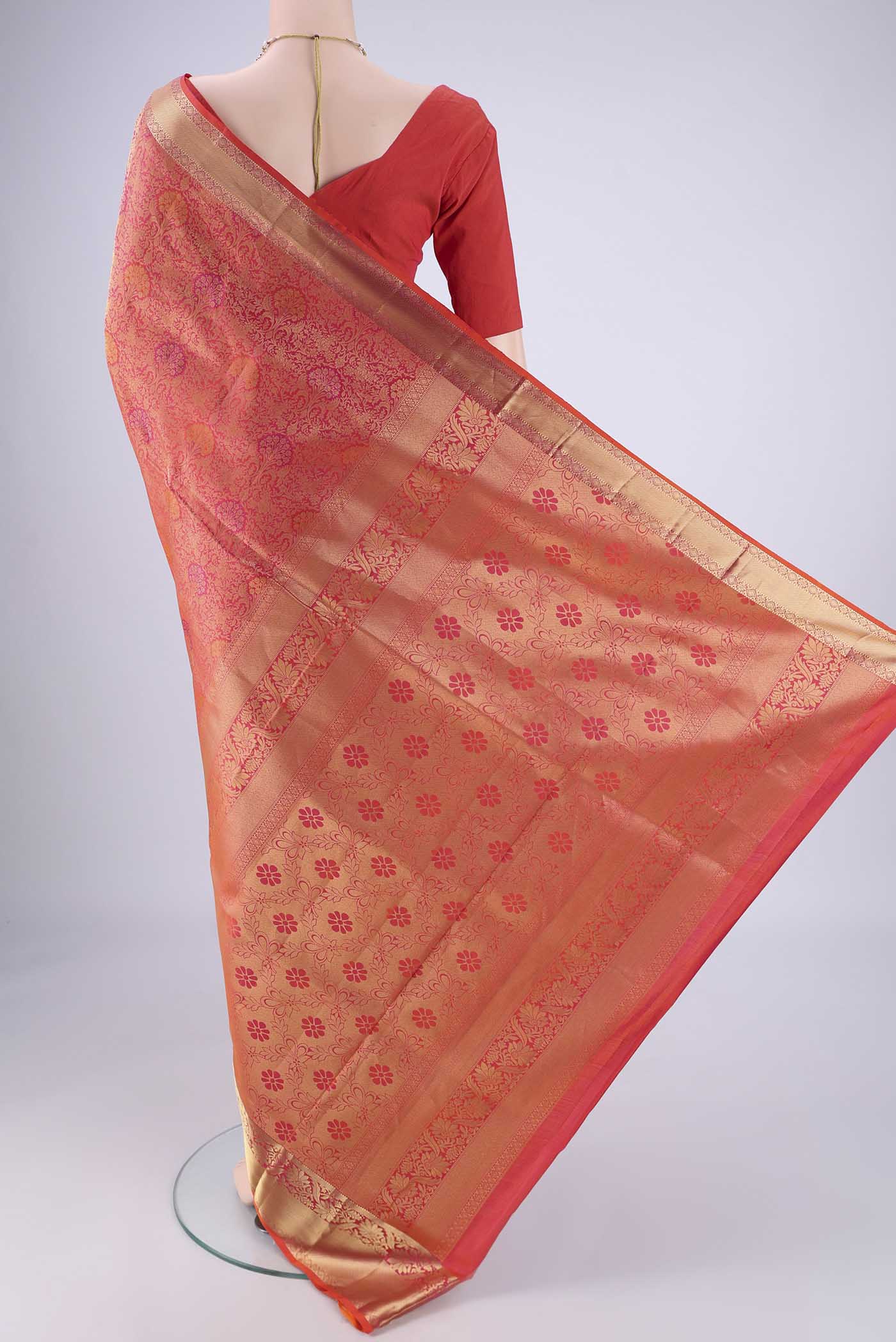 Flat view of Coral Soft Silk Saree with Zari Brocade on the body and Zari Border. 