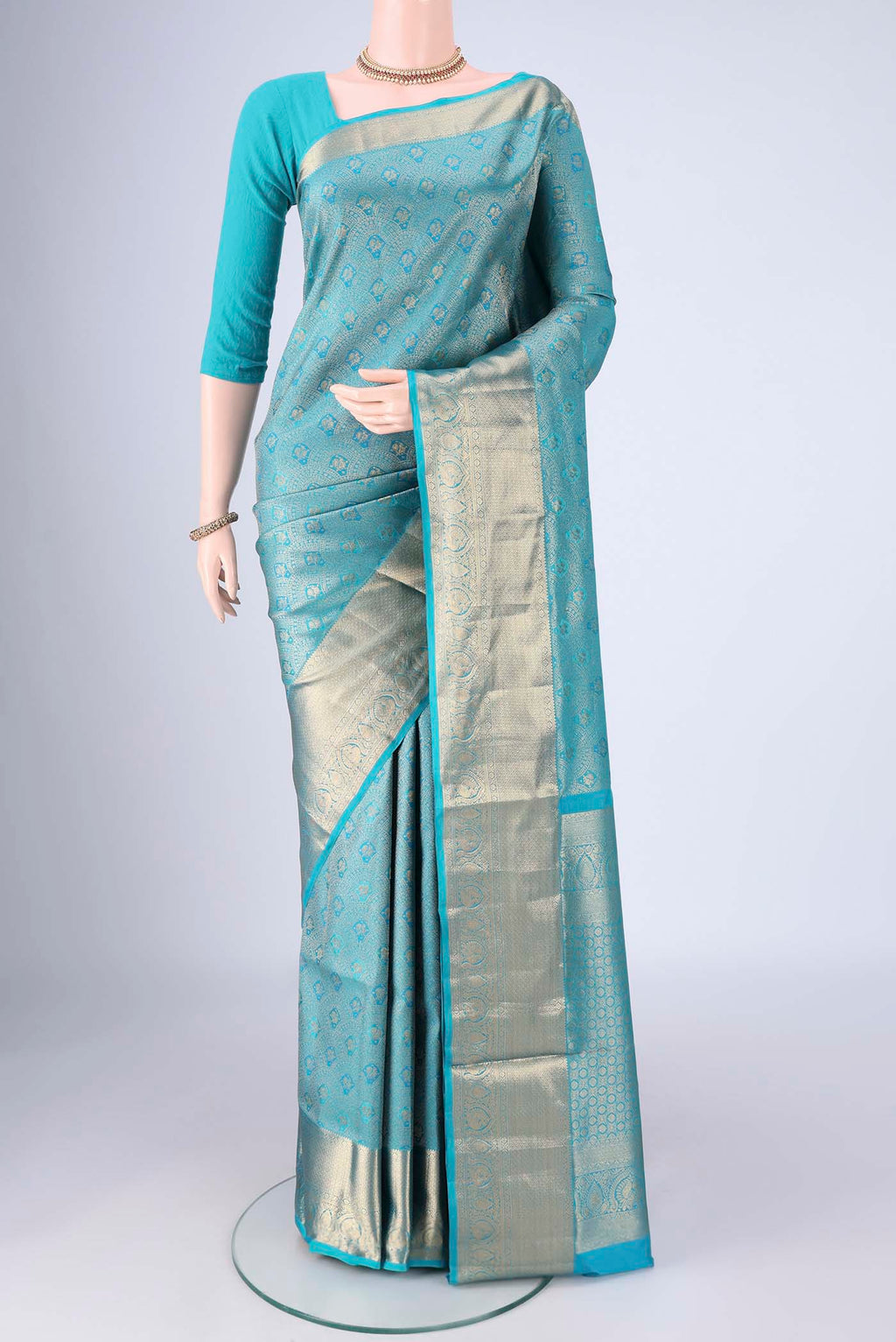 Turquoise Soft Silk Saree with Zari Brocade on the body and Zari Border.  displayed on a mannequin