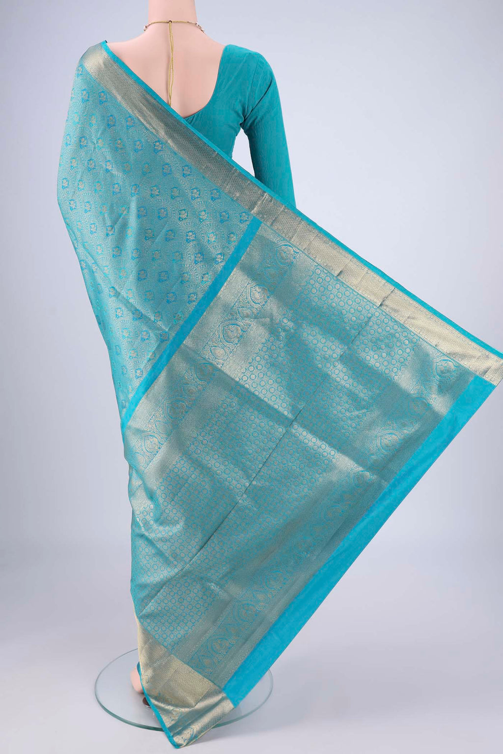 Flat view of Turquoise Soft Silk Saree with Zari Brocade on the body and Zari Border. 