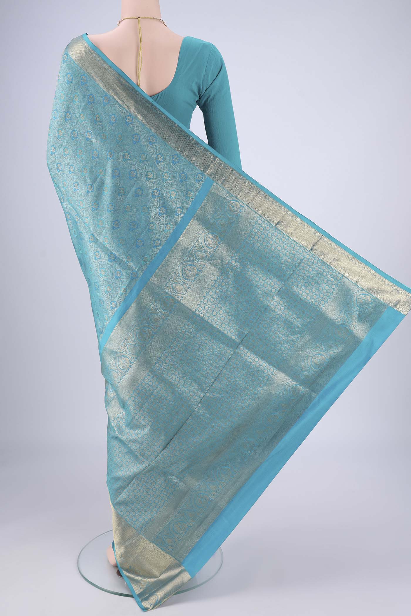 Flat view of Turquoise Soft Silk Saree with Zari Brocade on the body and Zari Border. 