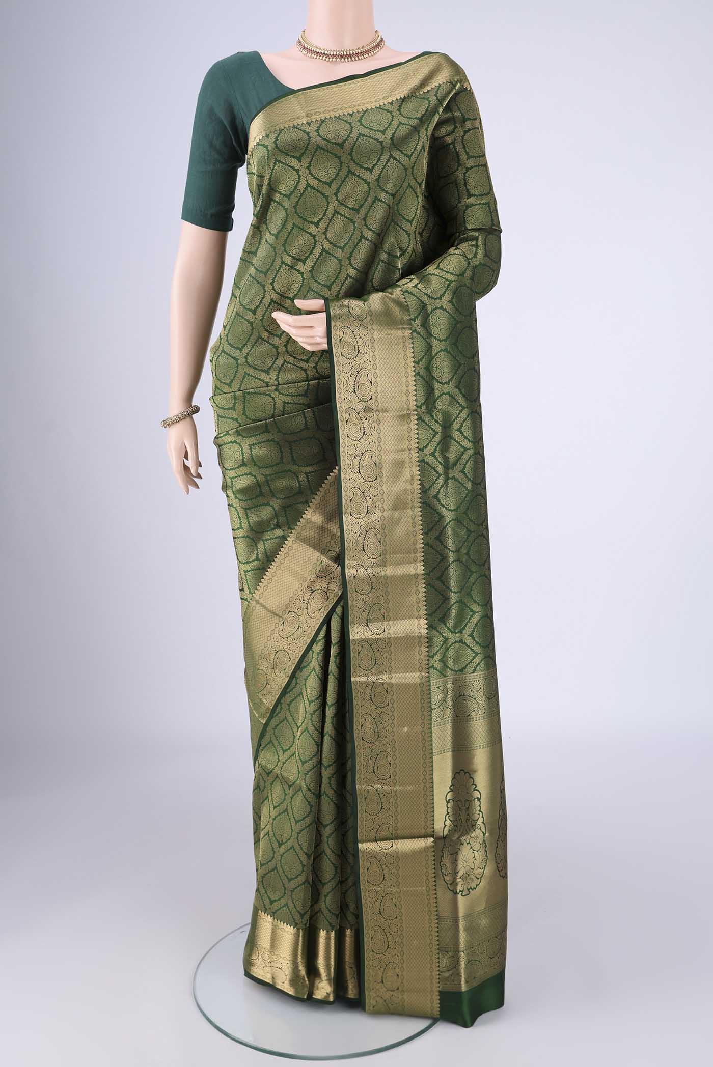 Bottle Green Soft Silk Saree with Zari Brocade on the body and Zari Border.  displayed on a mannequin