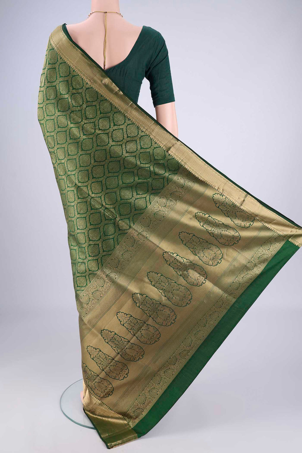 Flat view of Bottle Green Soft Silk Saree with Zari Brocade on the body and Zari Border. 