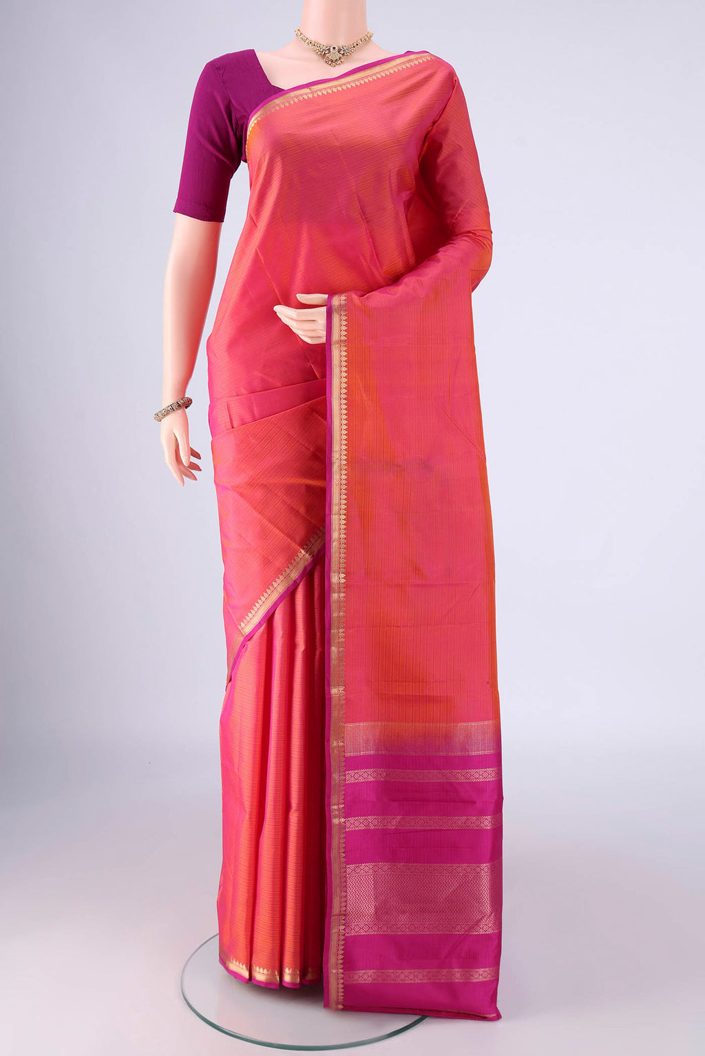 Multi Color Kanjivaram Silk Saree with Plain Body and Zari Border.  displayed on a mannequin