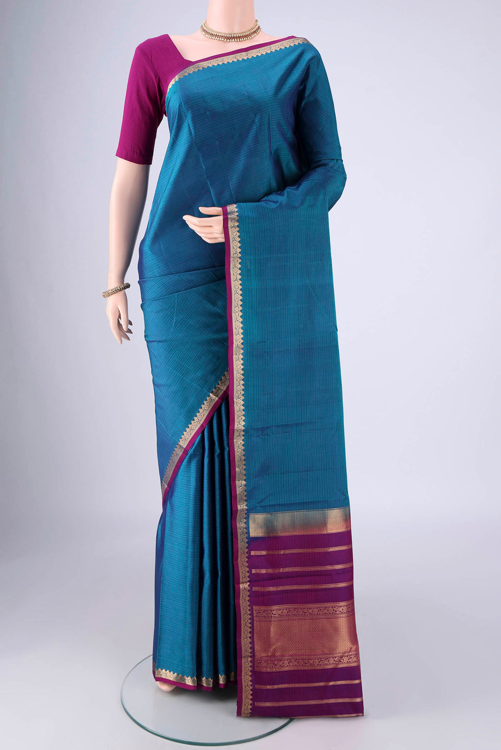 Blue Kanjivaram Silk Saree with Stripes on the body and Zari Border.  displayed on a mannequin