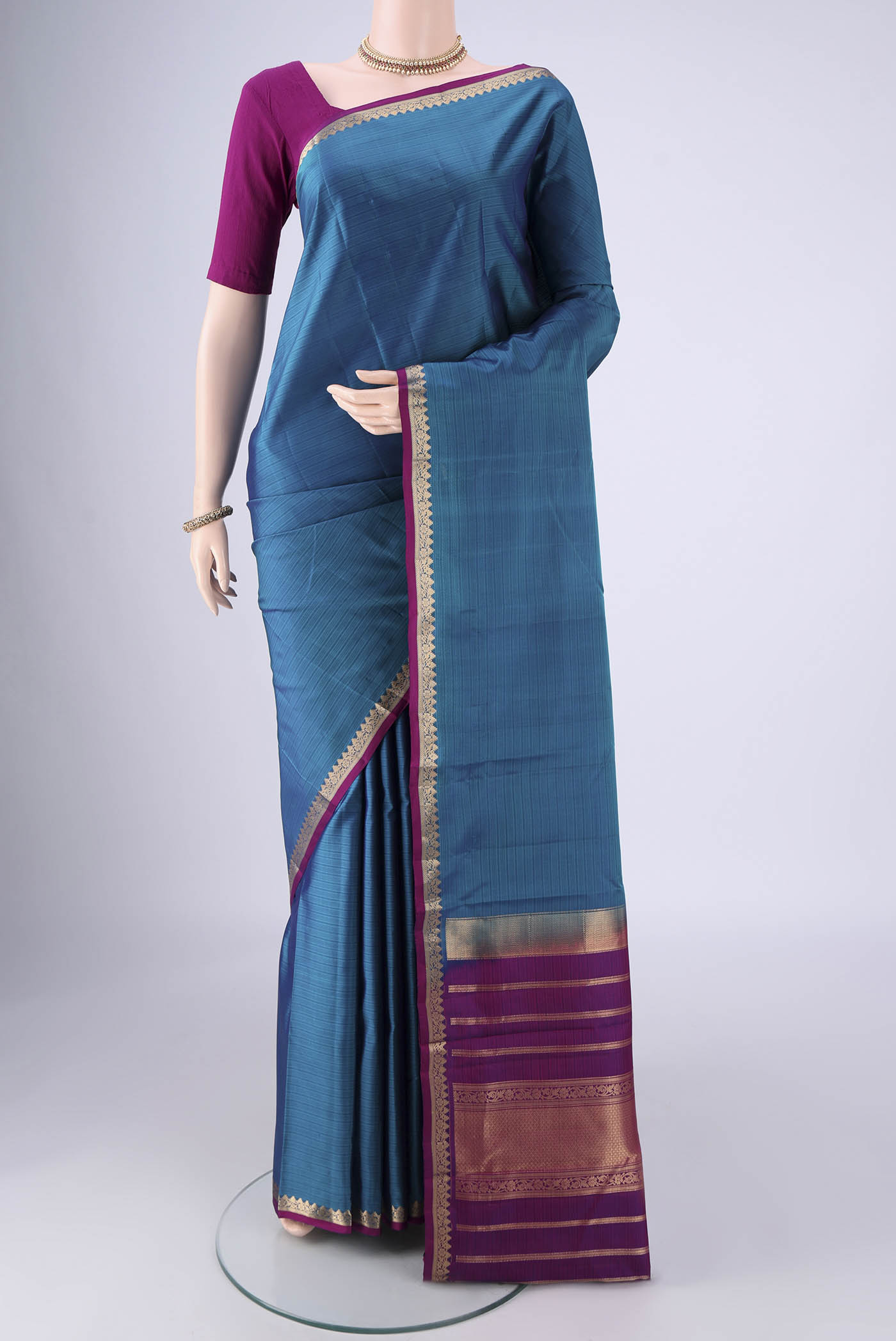 Blue Kanjivaram Silk Saree with Stripes on the body and Zari Border.  displayed on a mannequin