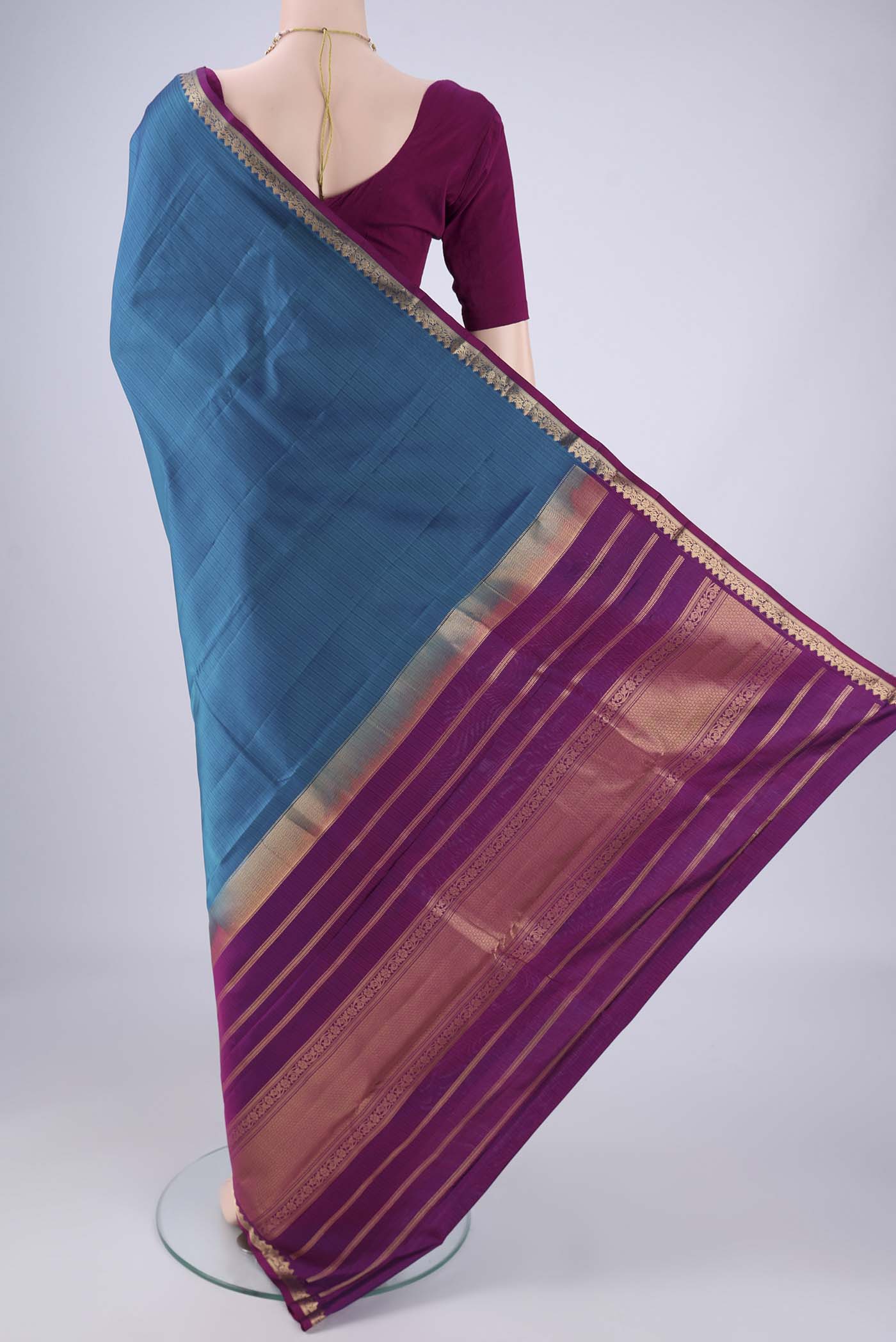 Flat view of Blue Kanjivaram Silk Saree with Stripes on the body and Zari Border. 