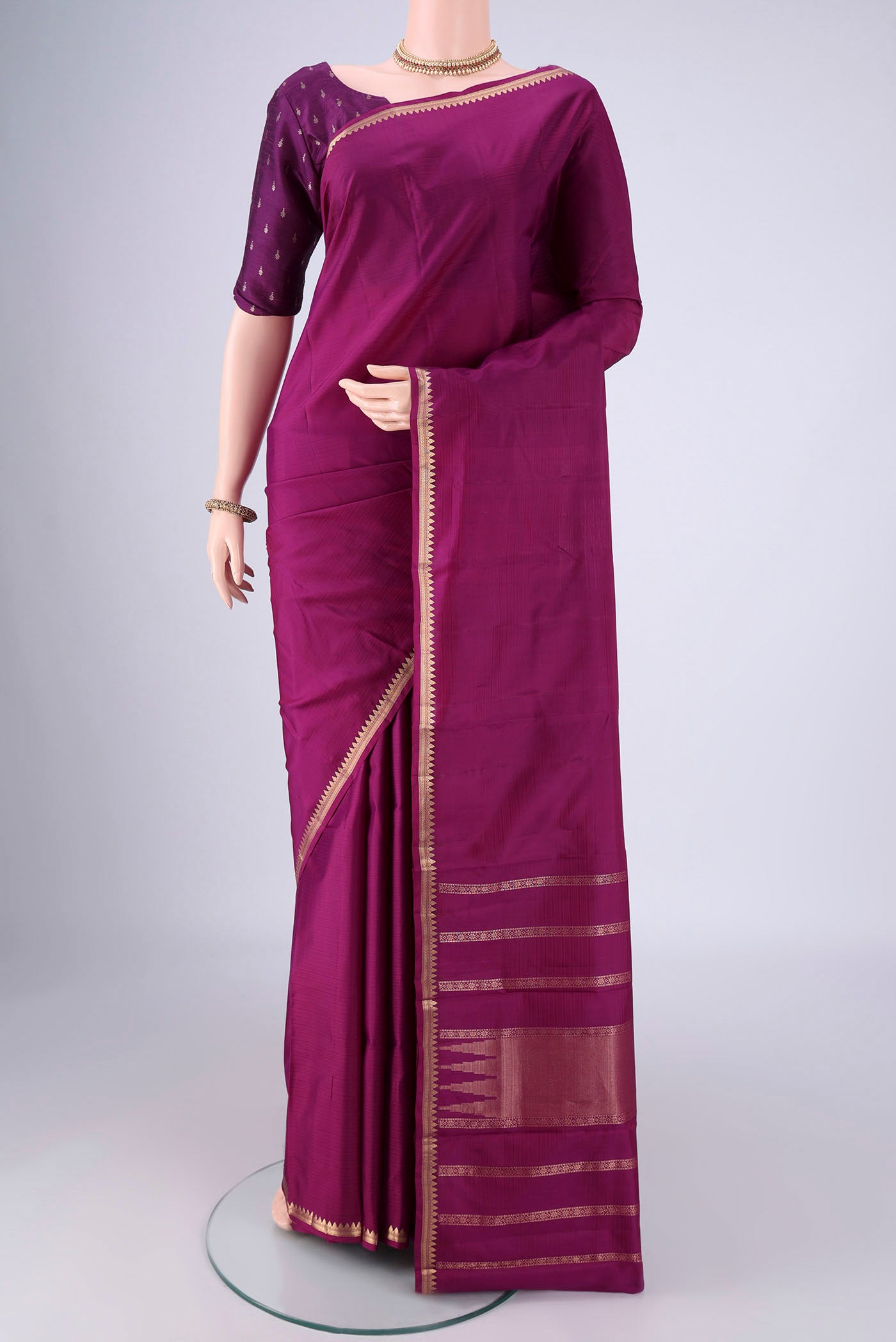Purple Kanjivaram Silk Saree with Stripes on the body and Zari Border.  displayed on a mannequin