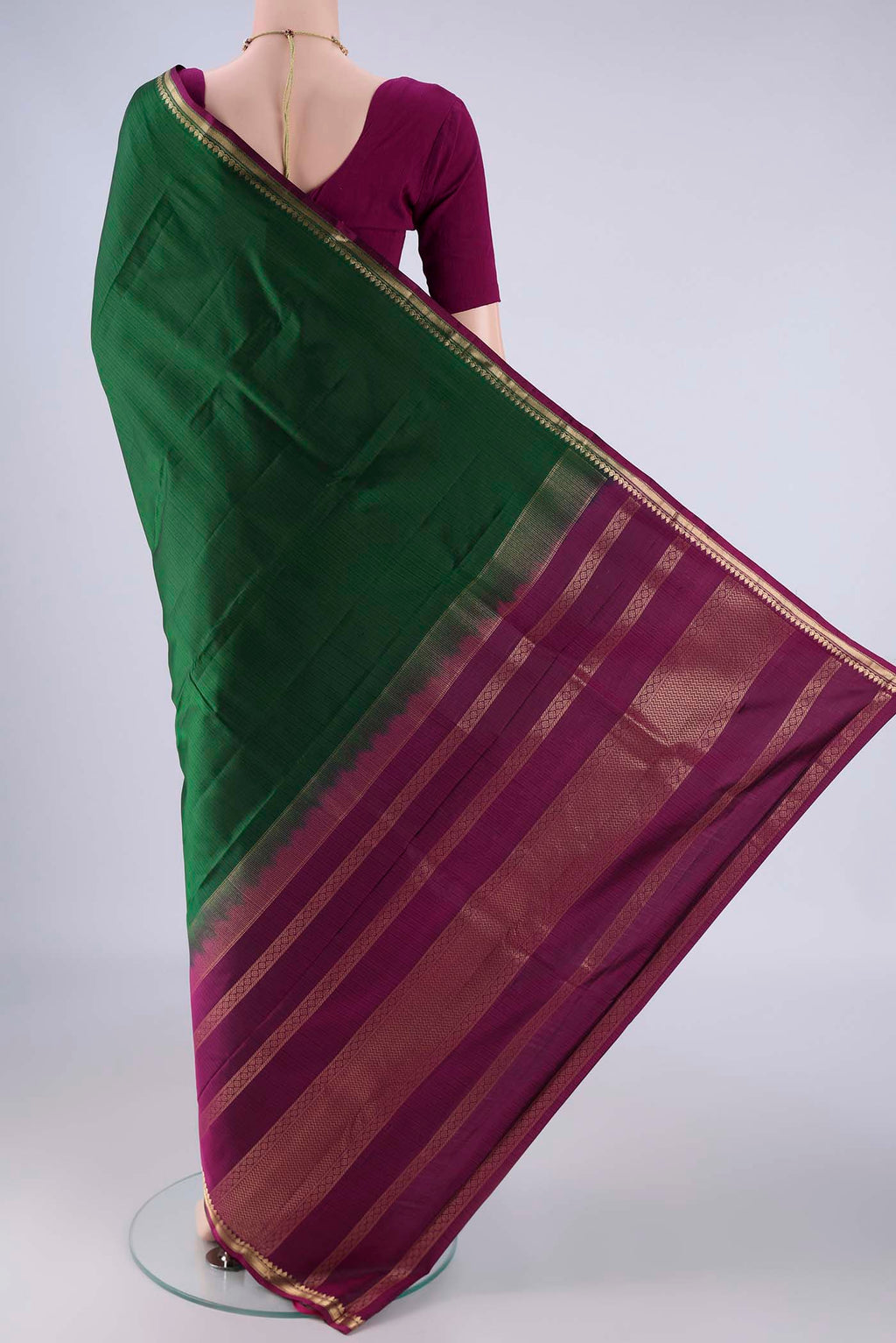 Flat view of Bottle Green Kanjivaram Silk Saree with Plain Body and Zari Border. 