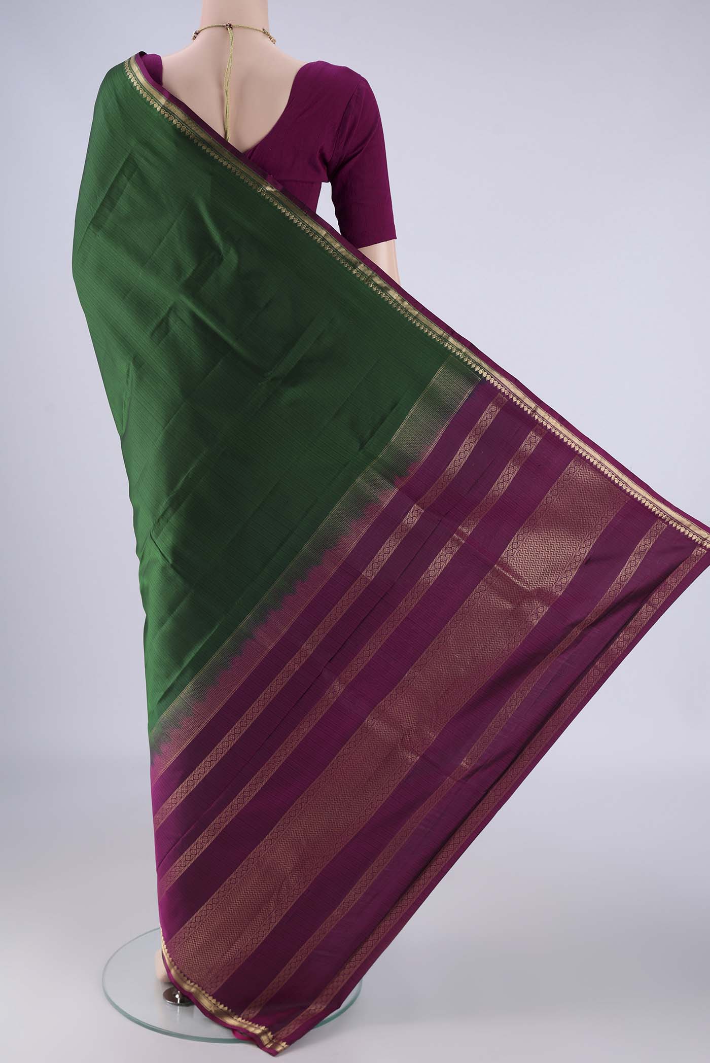 Flat view of Bottle Green Kanjivaram Silk Saree with Plain Body and Zari Border. 