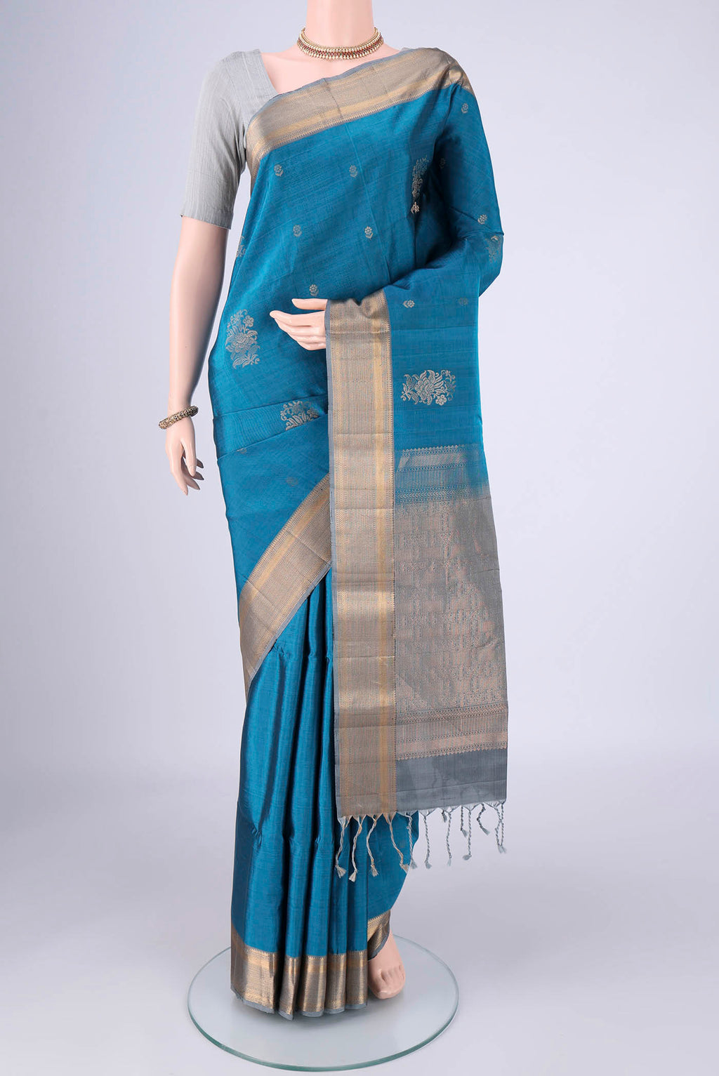Blue Soft Silk Saree with Zari Butta on the body and Zari Border.  displayed on a mannequin