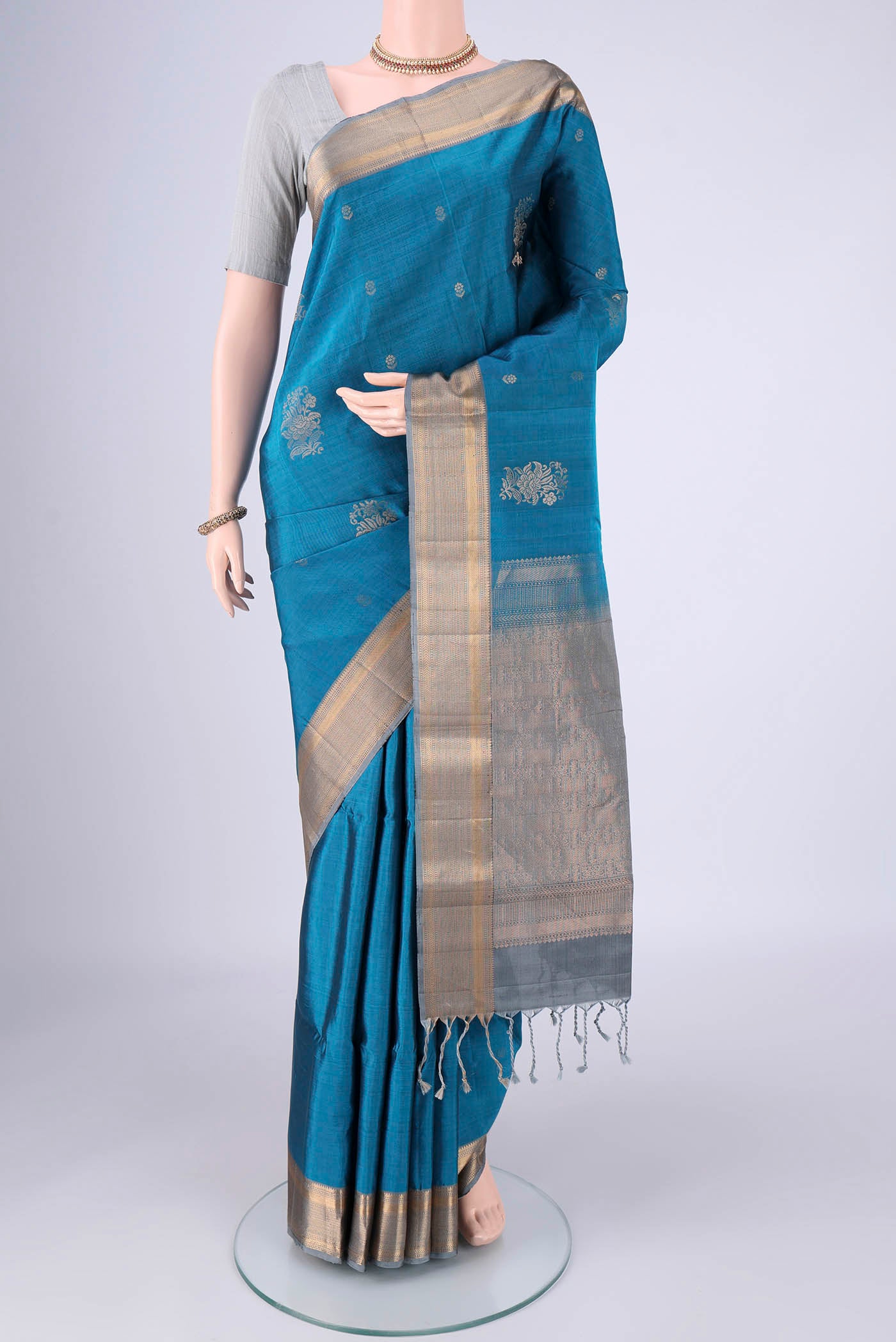 Blue Soft Silk Saree with Zari Butta on the body and Zari Border.  displayed on a mannequin
