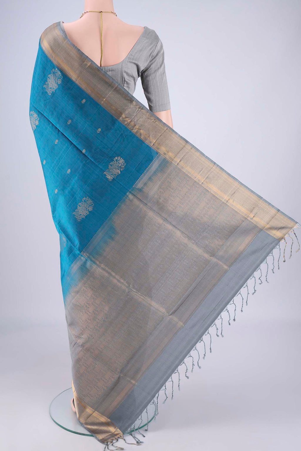 Flat view of Blue Soft Silk Saree with Zari Butta on the body and Zari Border. 