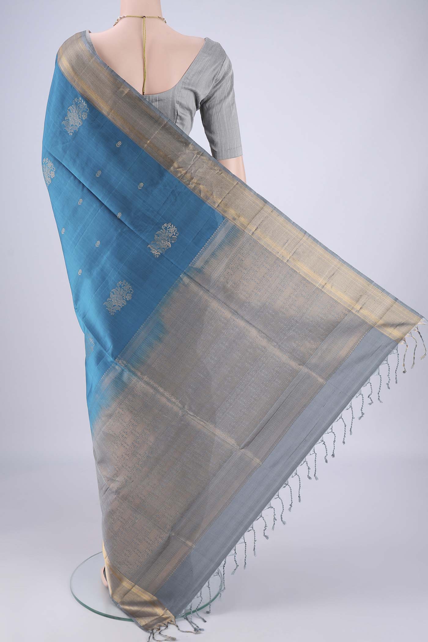 Flat view of Blue Soft Silk Saree with Zari Butta on the body and Zari Border. 