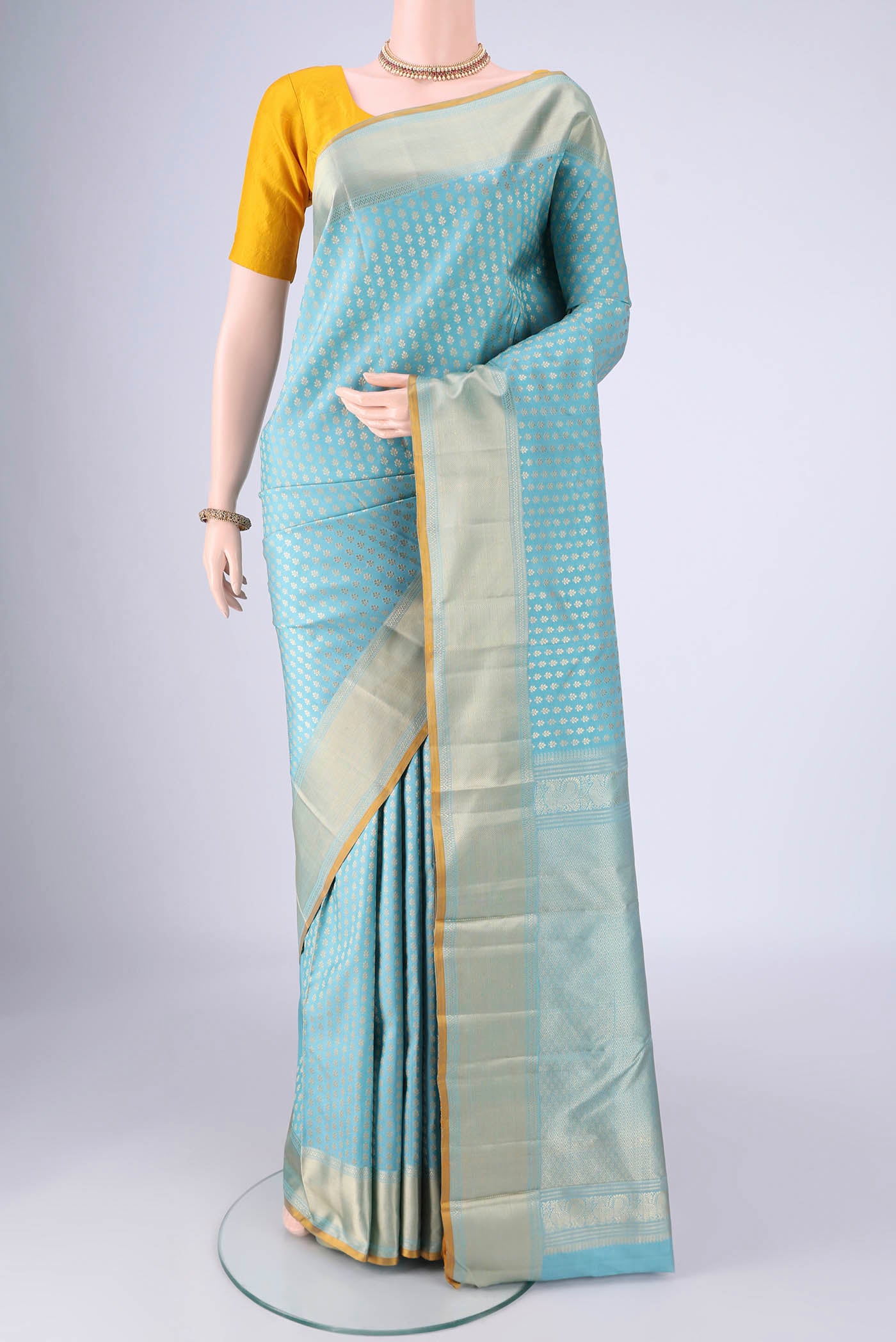Sky Blue Kanchipuram Silk Saree with Thread Brocade on the body and Thread Border.  displayed on a mannequin