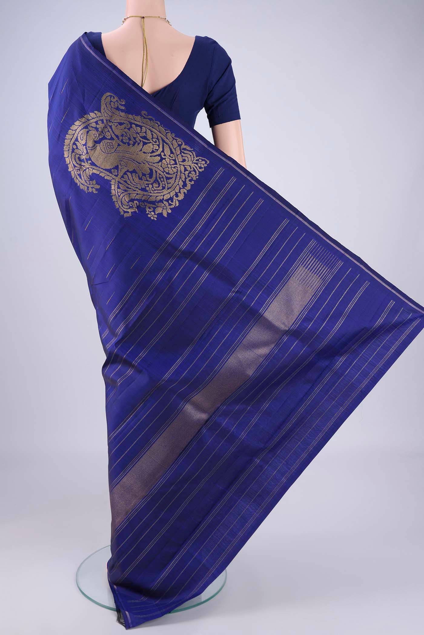 Flat view of Dark Blue Kanjivaram Silk Saree with Zari Butta on the body and Plain Border. 