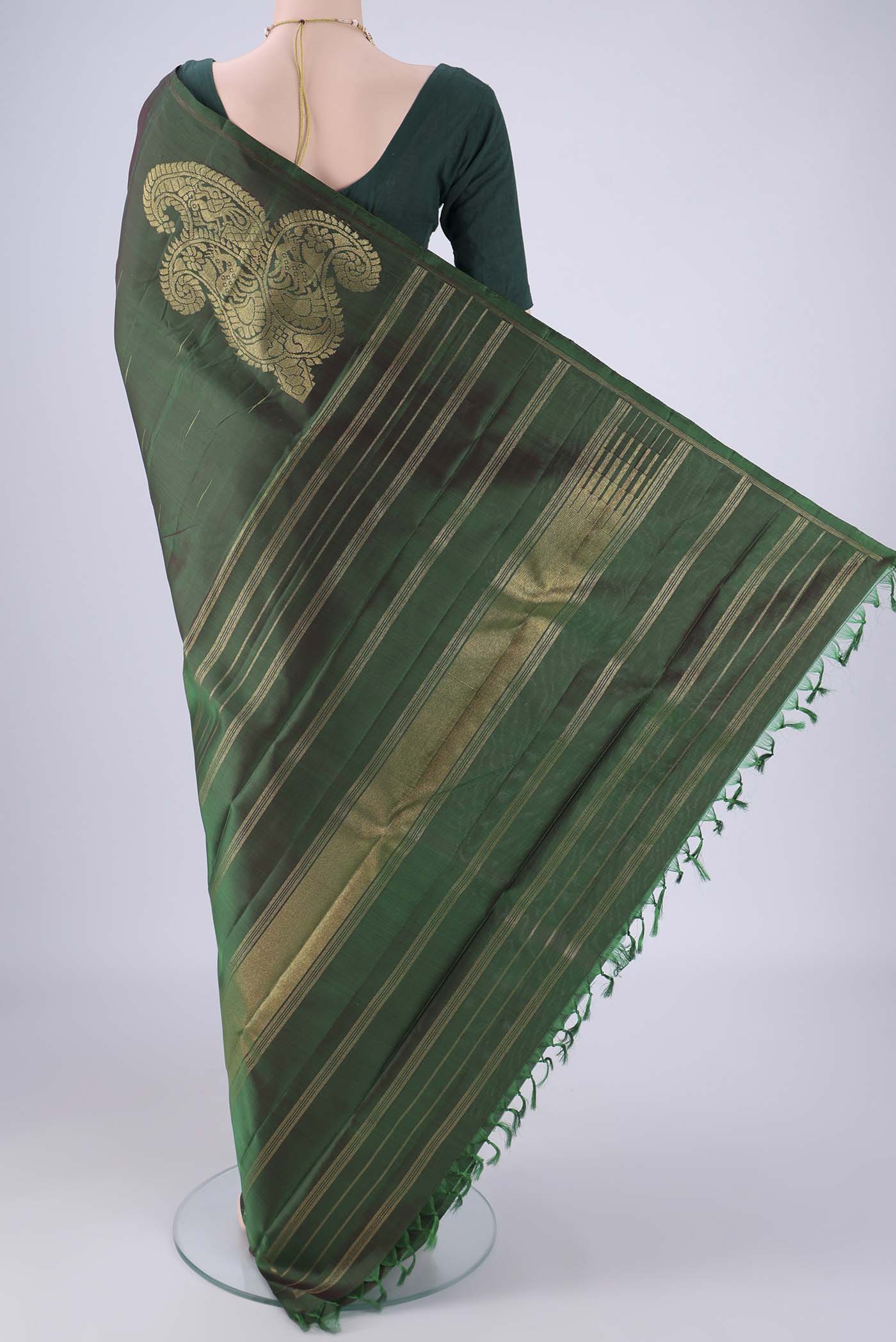 Flat view of Bottle Green Kanjivaram Silk Saree with Zari Butta on the body and Plain Border. 