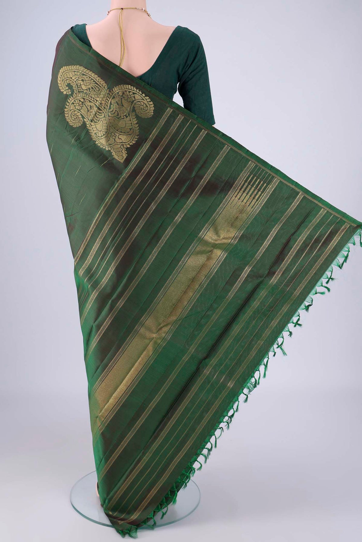 Flat view of Bottle Green Kanjivaram Silk Saree with Zari Butta on the body and Plain Border. 