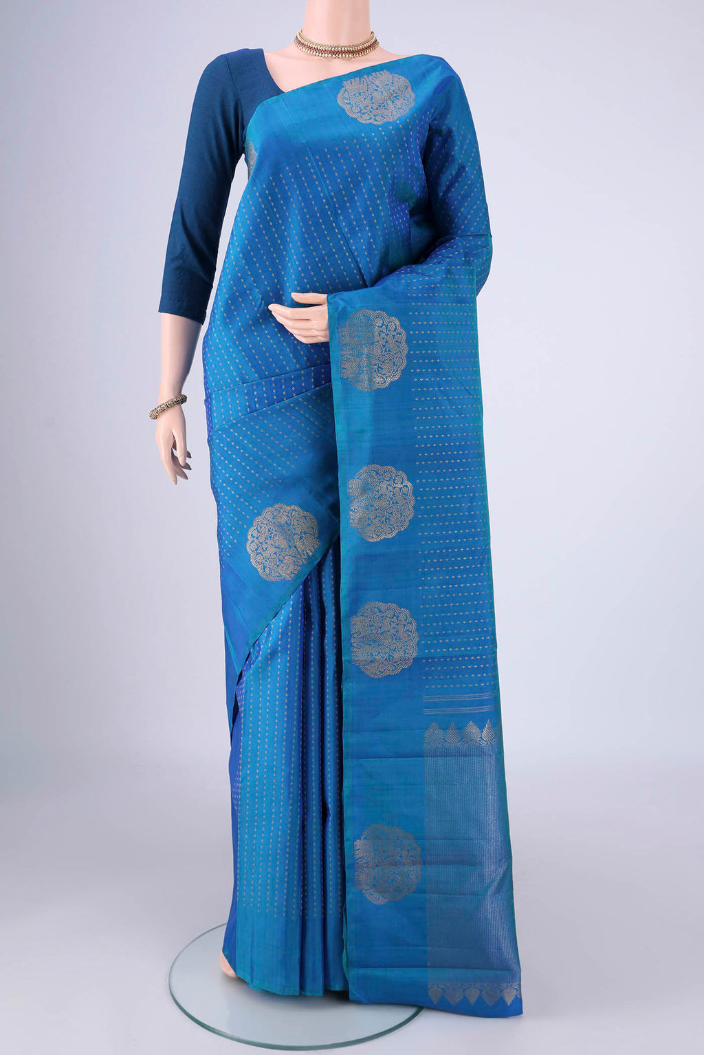 Blue Kanchipuram Silk Saree with Zari Butta on the body and Fancy Border.  displayed on a mannequin