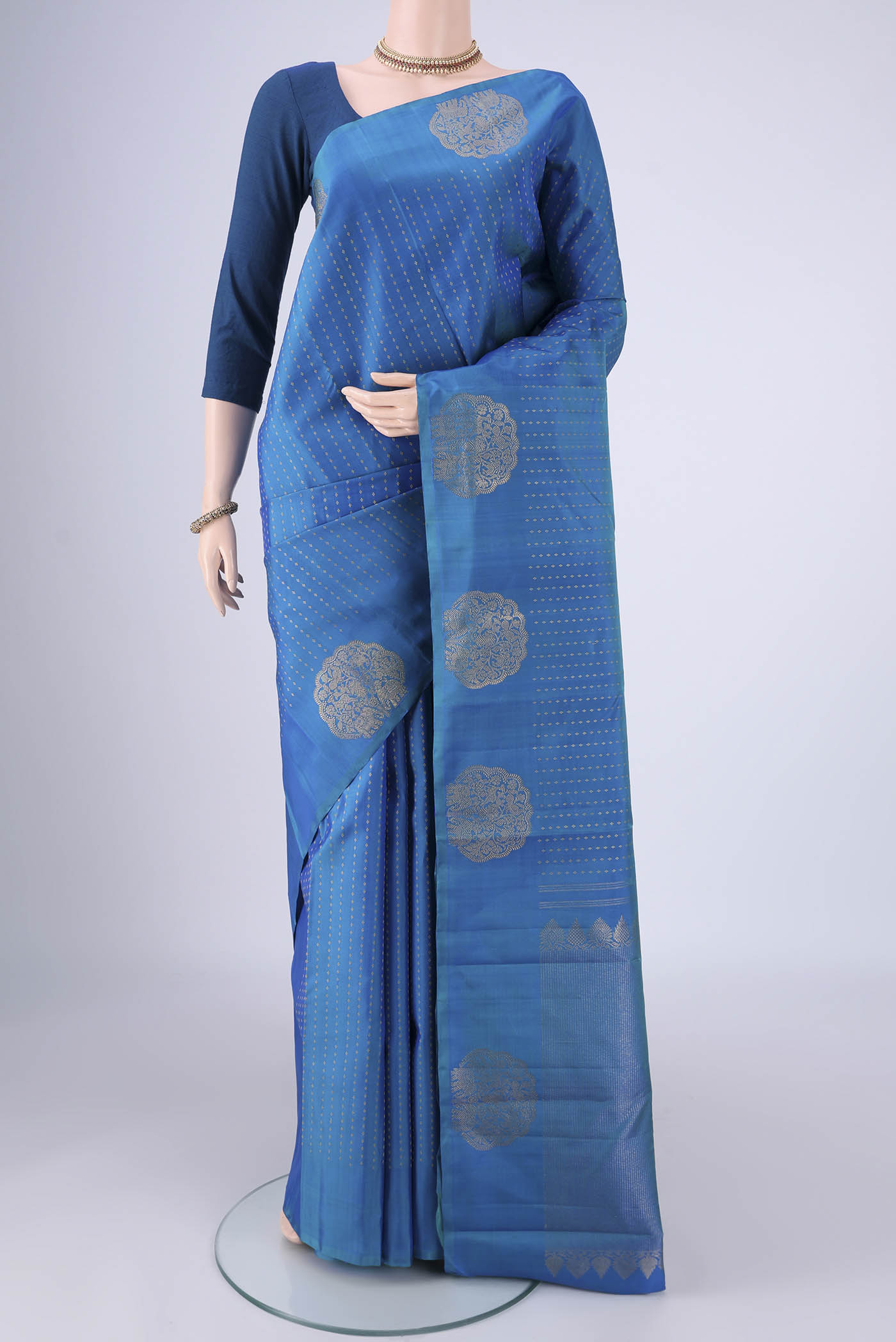 Blue Kanchipuram Silk Saree with Zari Butta on the body and Fancy Border.  displayed on a mannequin