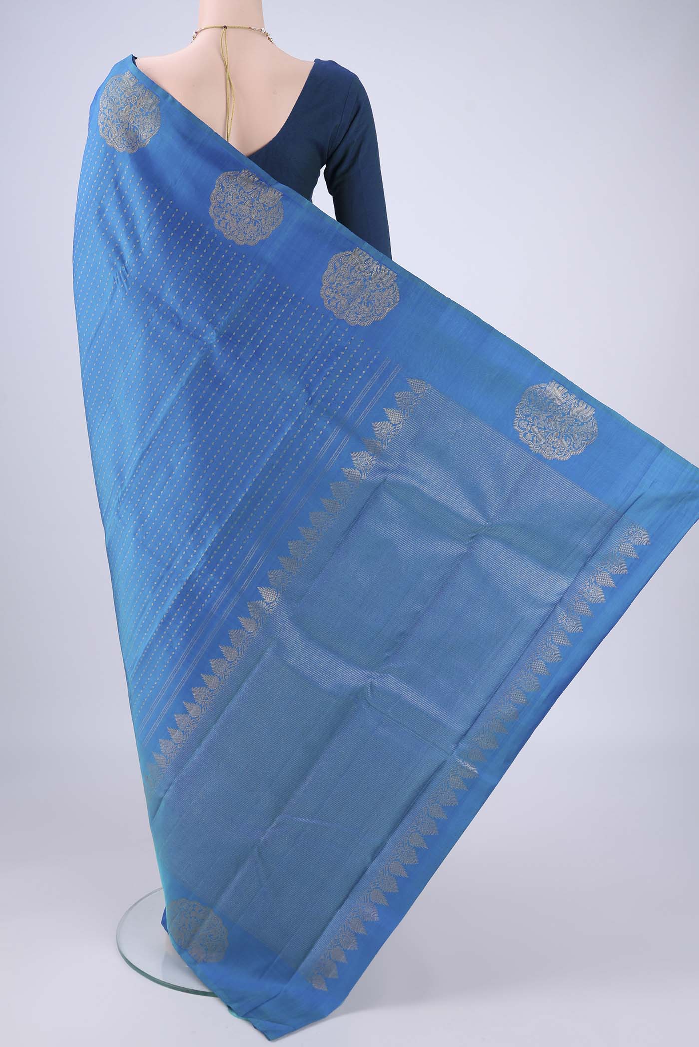 Flat view of Blue Kanchipuram Silk Saree with Zari Butta on the body and Fancy Border. 