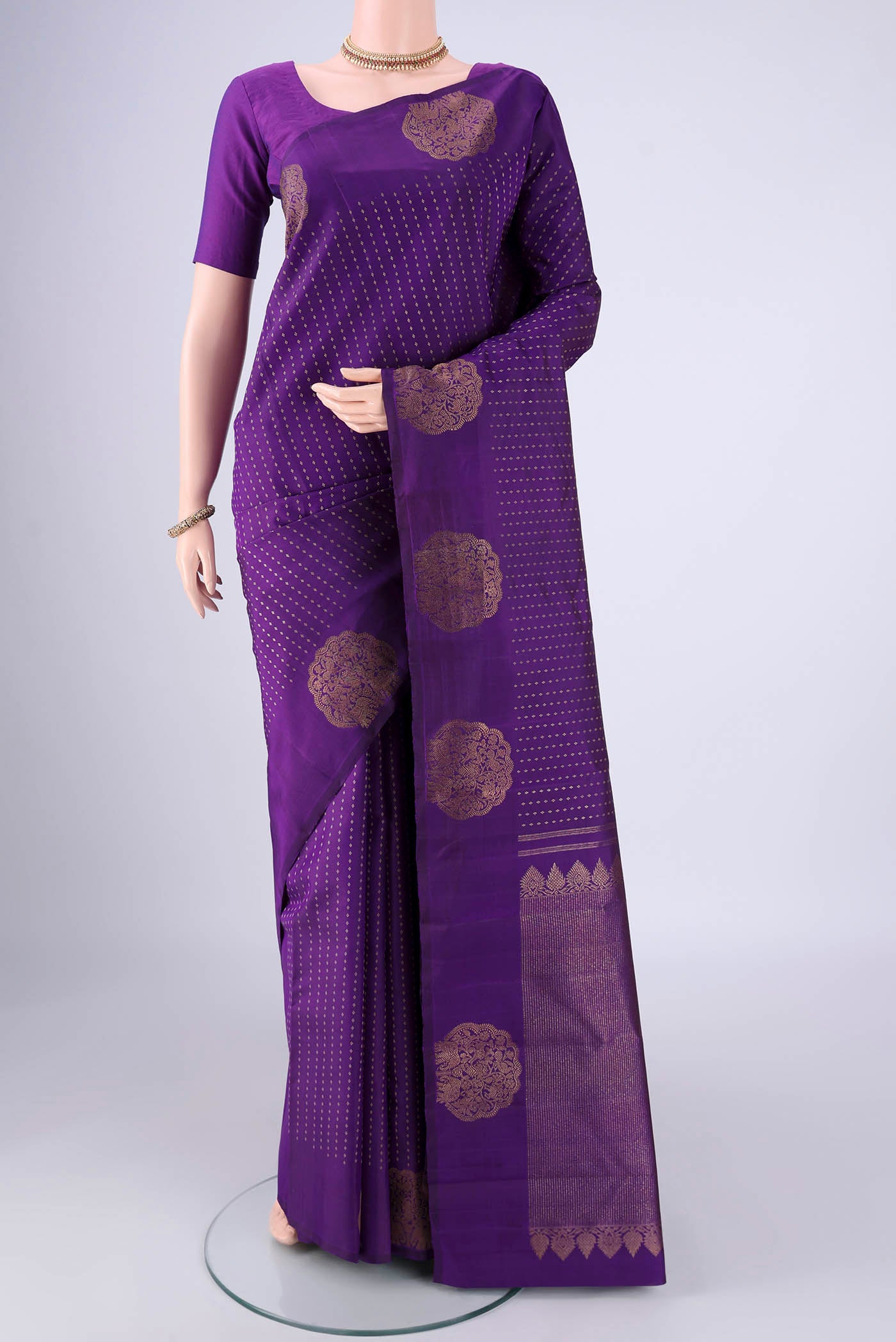 Purple Kanchipuram Silk Saree with Zari Butta on the body and Fancy Border.  displayed on a mannequin
