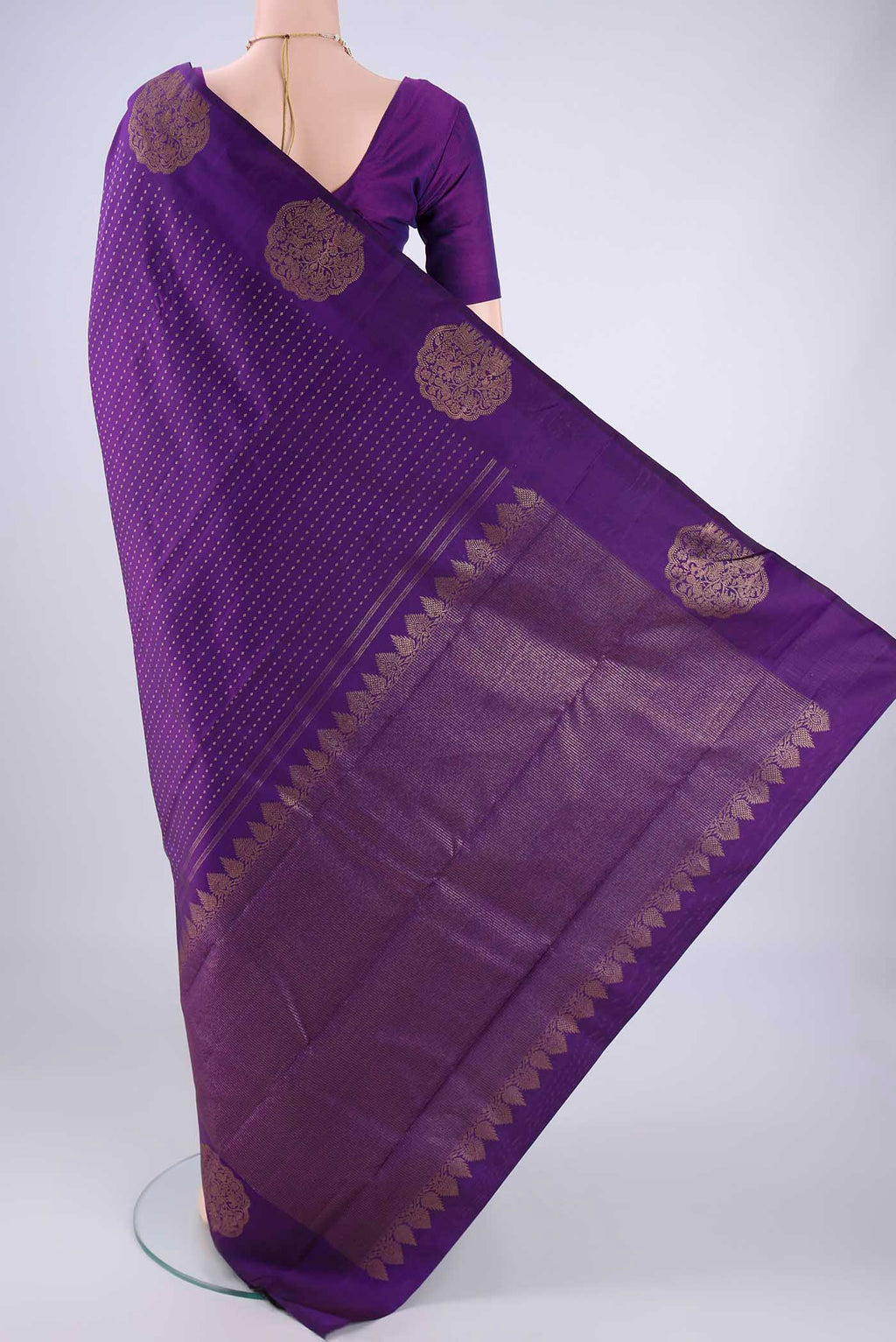 Flat view of Purple Kanchipuram Silk Saree with Zari Butta on the body and Fancy Border. 
